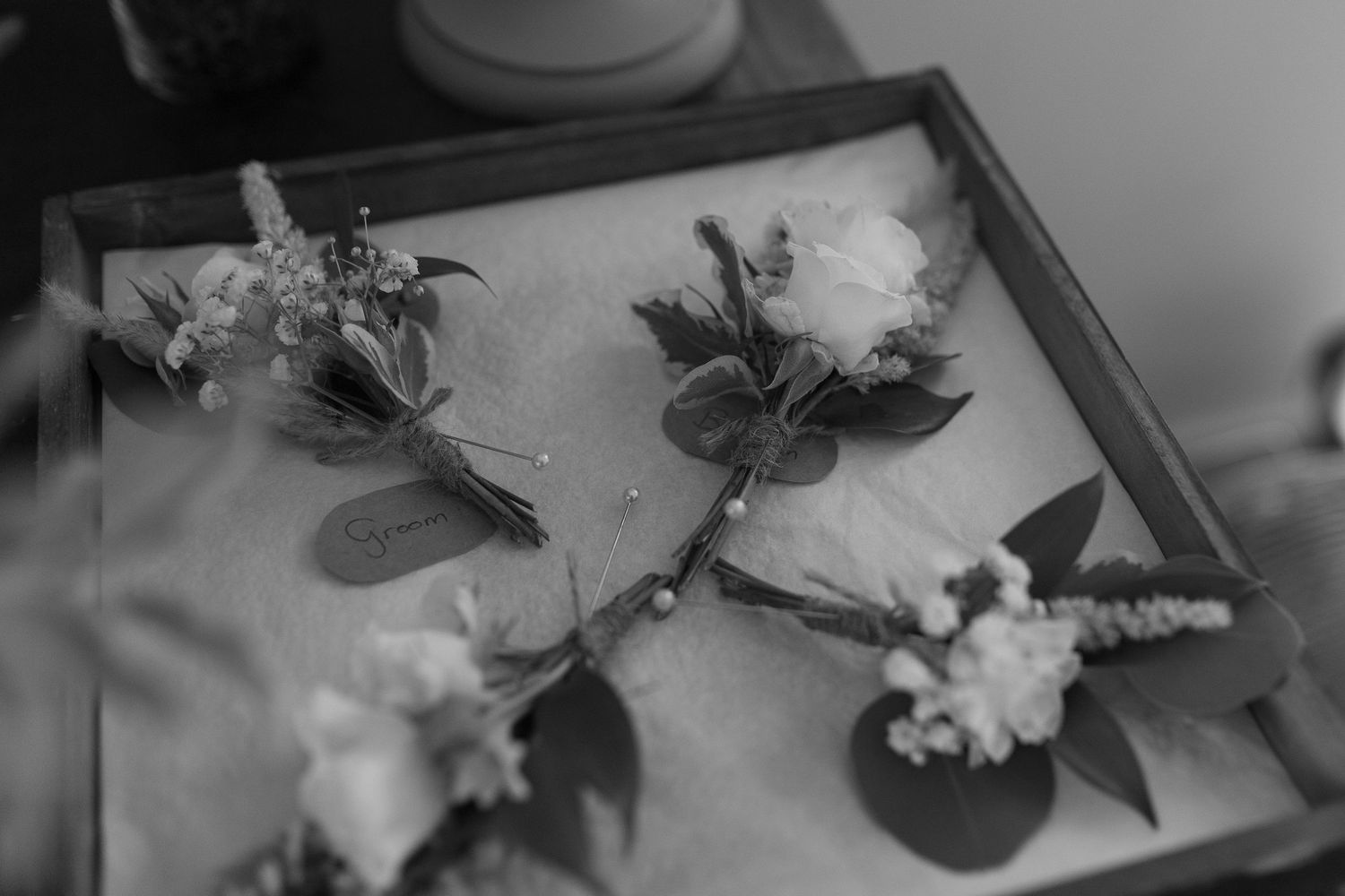 Black and White photo of the groom's and groomsmen buttonholes
