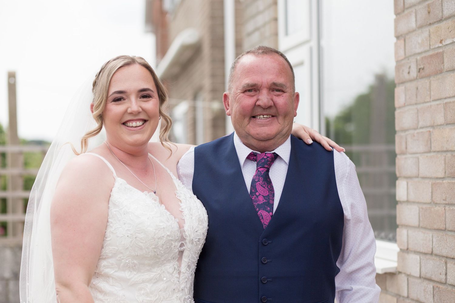 Close up of a bride and her dad smiling for a photo