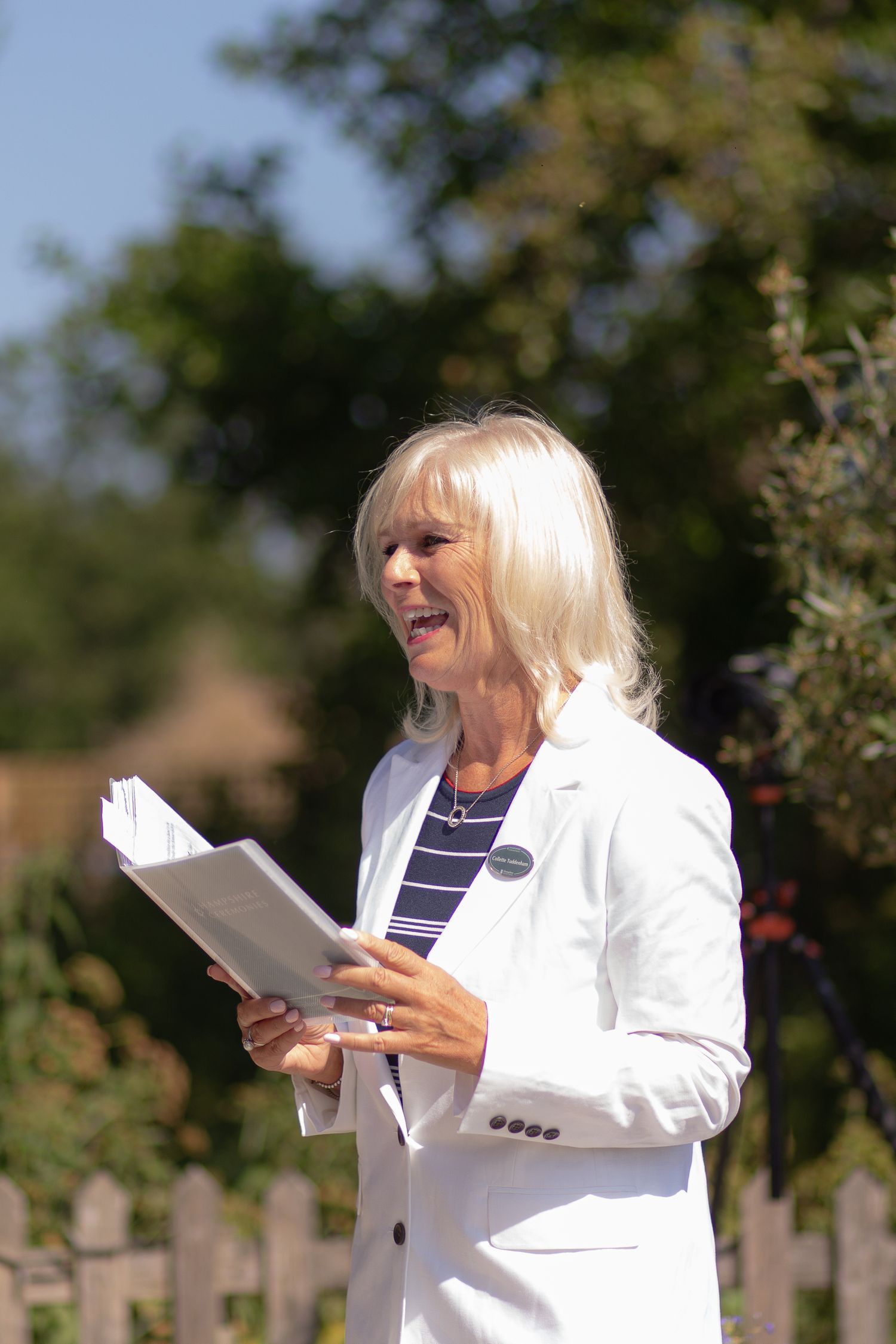 Female registrar from Hampshire Ceremonies leading a wedding ceremony outdoors at Sopley Mill