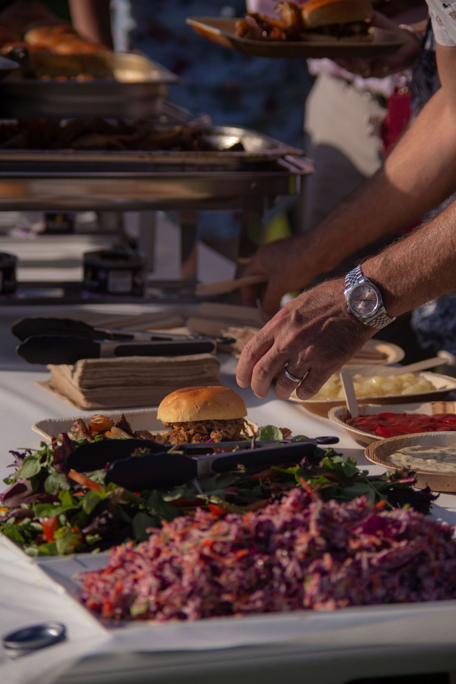 Evening food laid out on the table. Salads and sides waiting to be placed on guests plates.