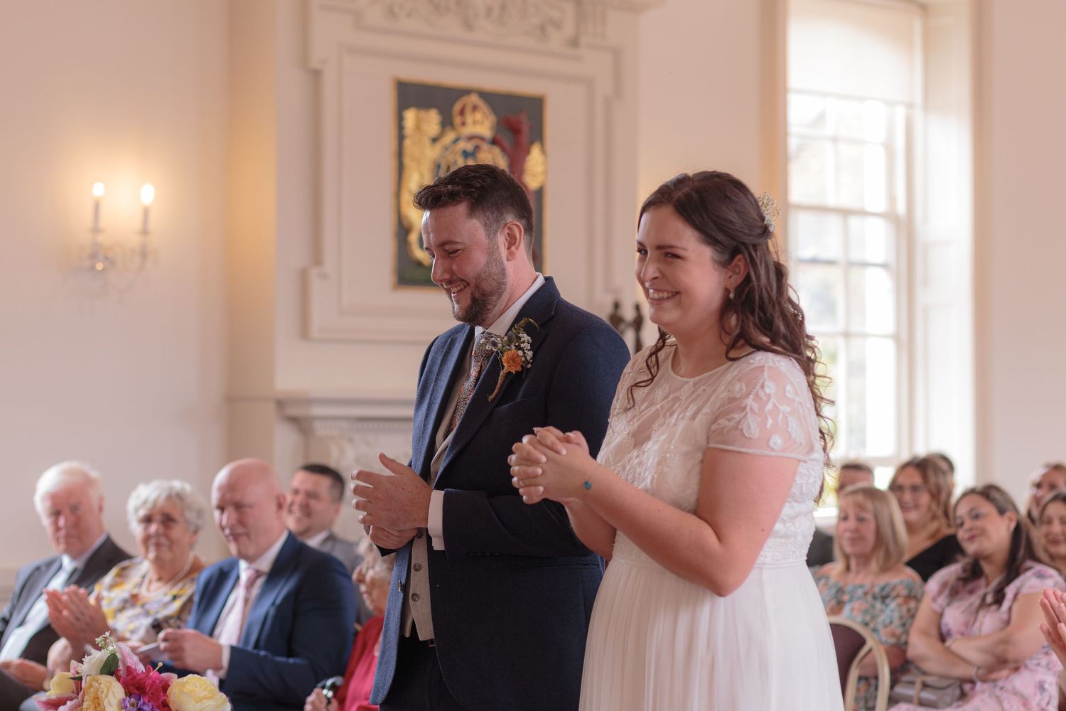 Bride and groom laughing, as the clap for the Bride's father at the end of his speech