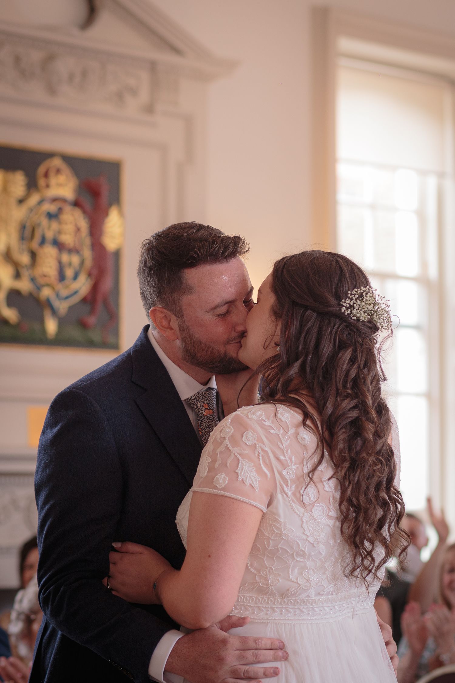 Bride and Groom share their first kiss in the middle of their wedding ceremony