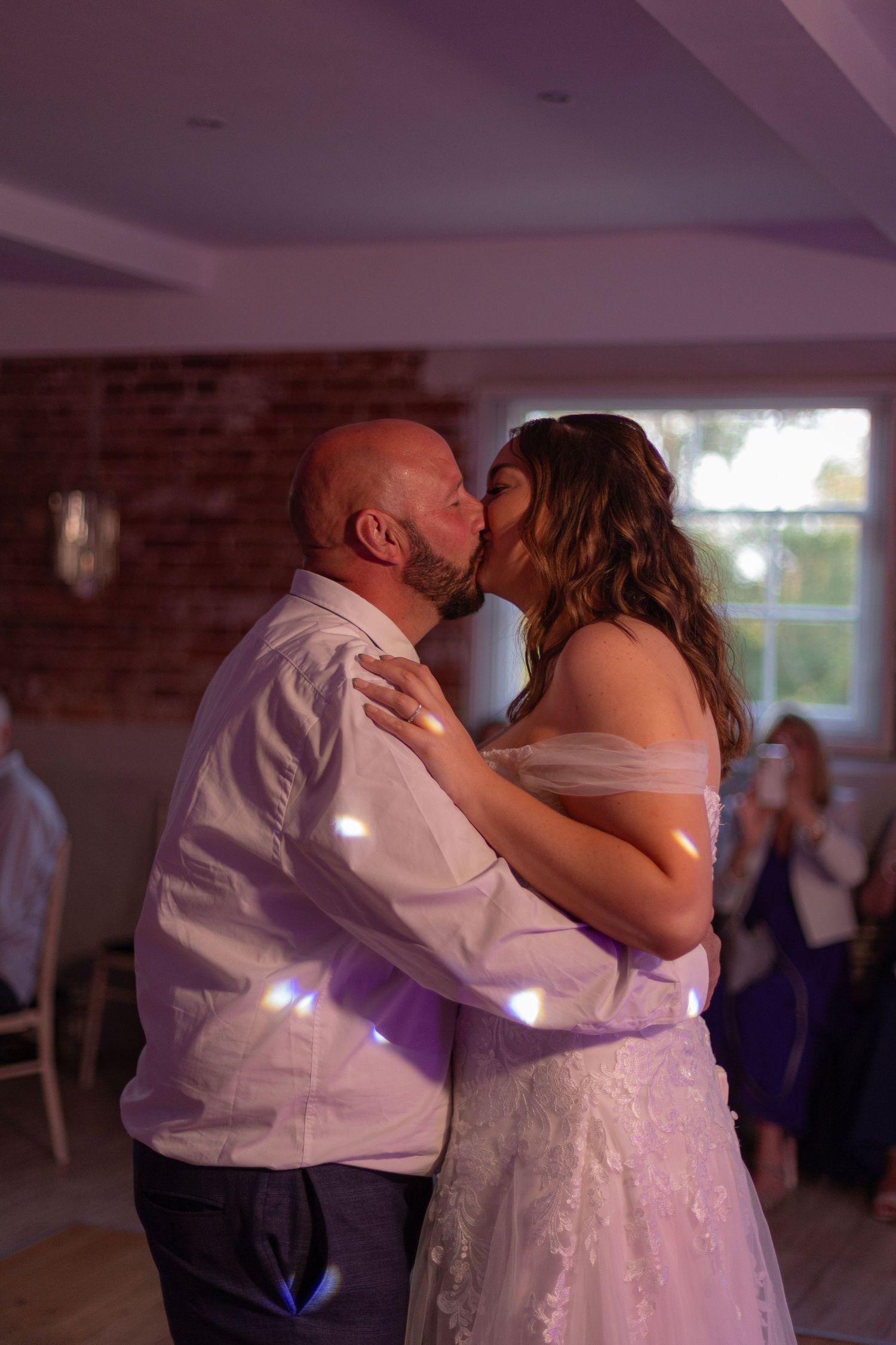Bride and Groom share a kiss on the dancefloor in the middle off their first dance