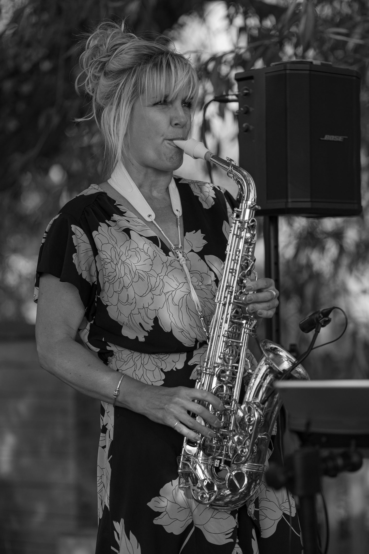 Black and White photo of a female saxophone player, playing the brides aisle walk song