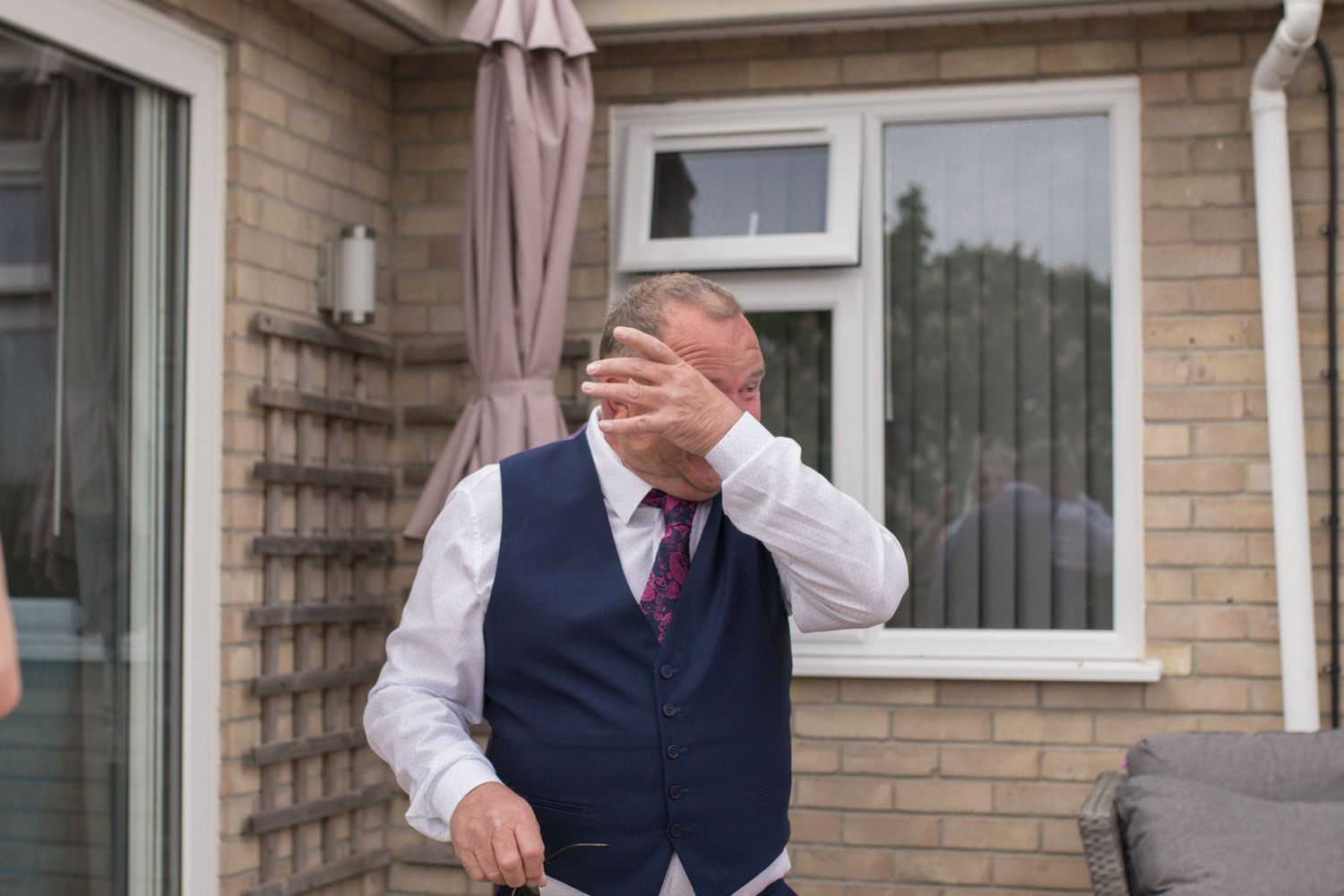 Bride’s father wiping his tears after seeing his daughter in her wedding dress for the first time.
