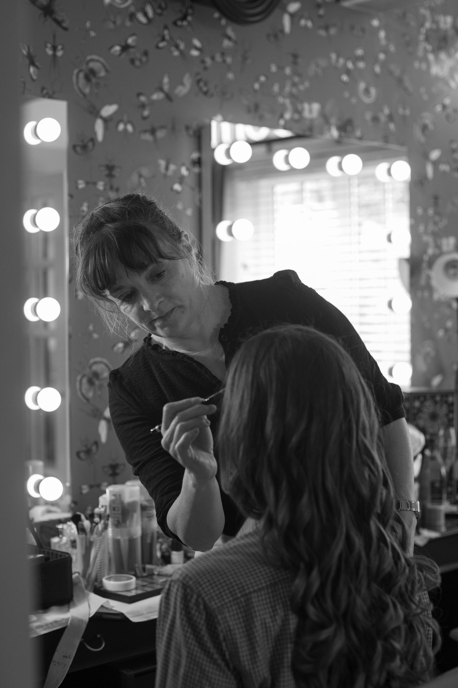 Make up artist hard at work, painting on the bride's eye shadow