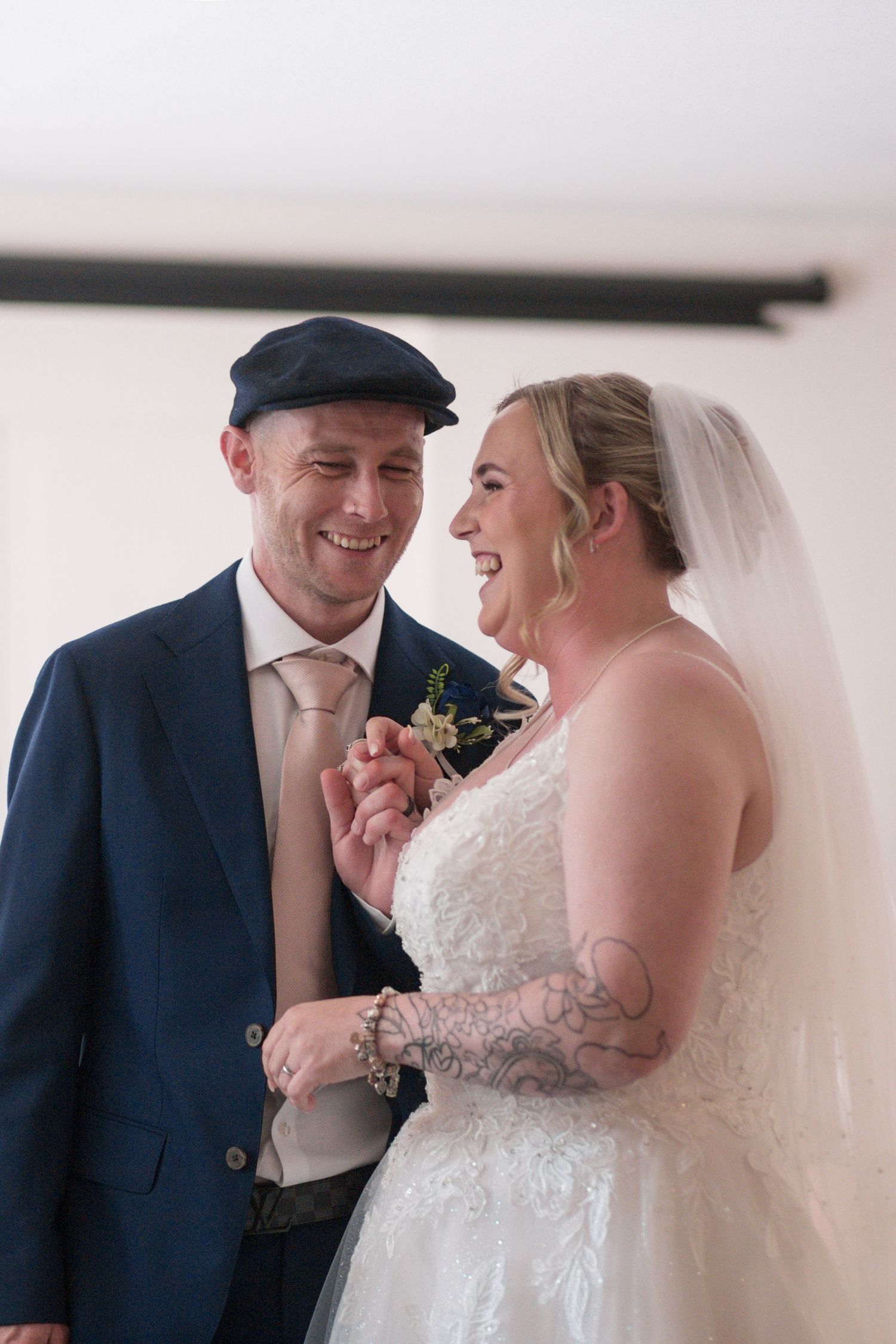 Bride and Groom huddled together laughing during their wedding ceremony at the Hotel Rembrandt