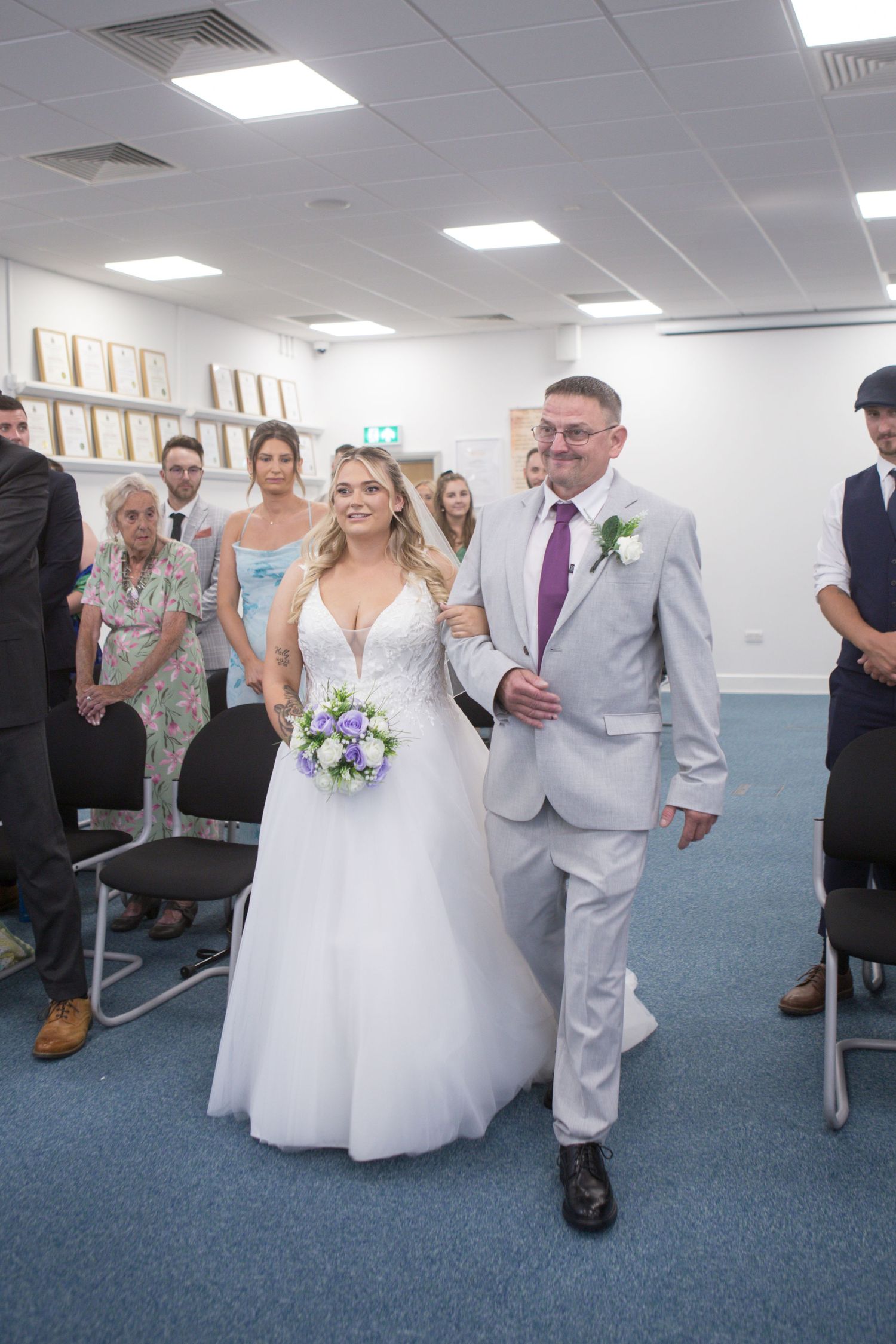 A Bride and her dad walking down the aisle together at the Weymouth Ceremony Rooms