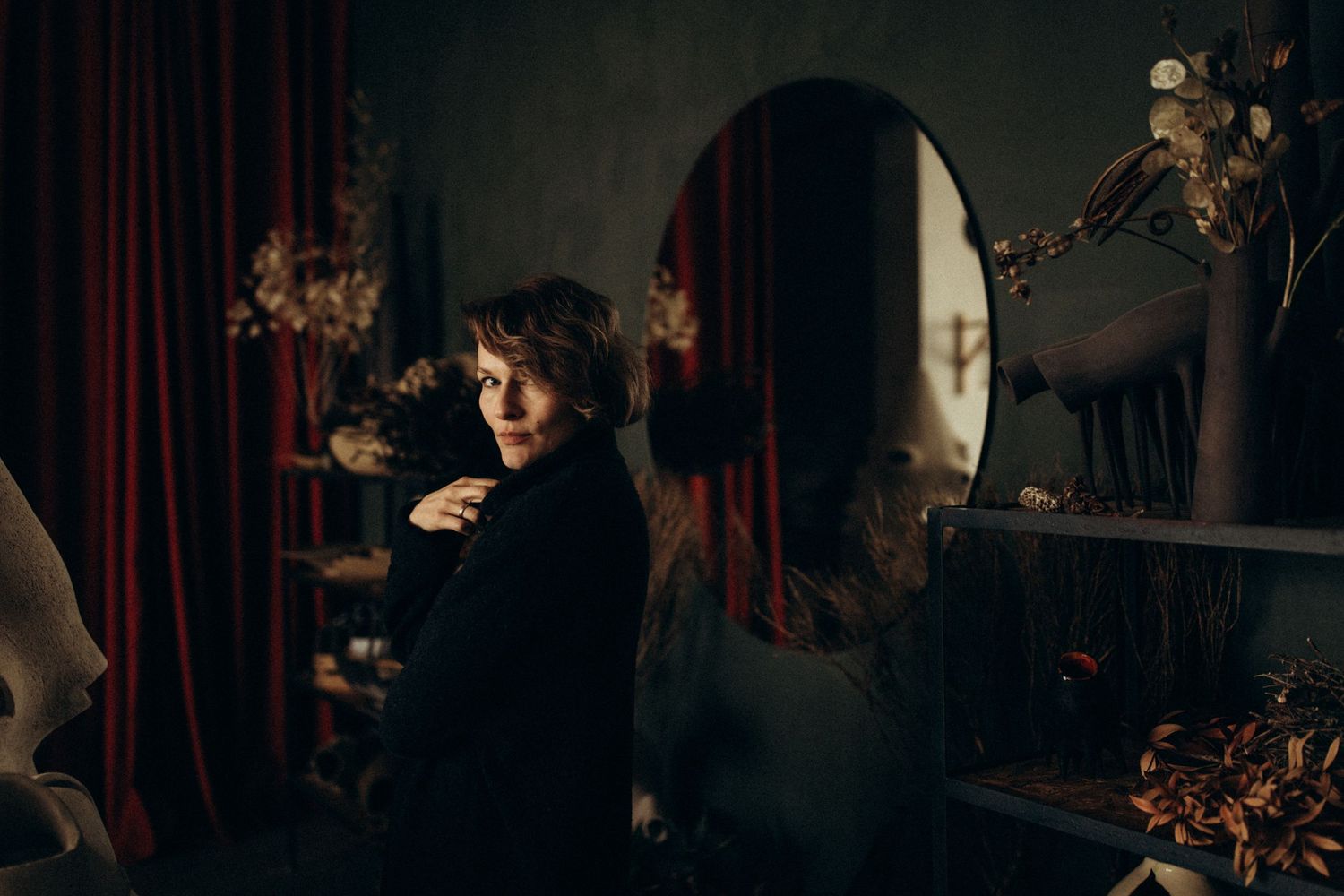 Dark and moody portrait sequence with theatrical mask and red curtain in background.
