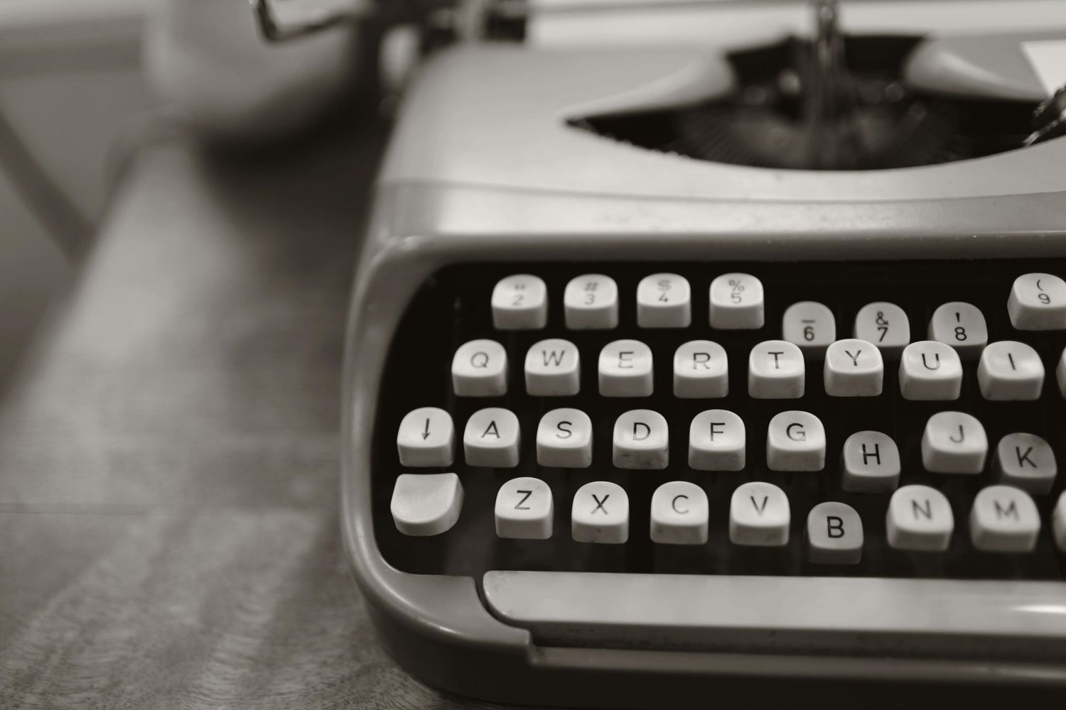 Vintage typewriter keys and mechanisms shown in detailed black and white close-up shots.