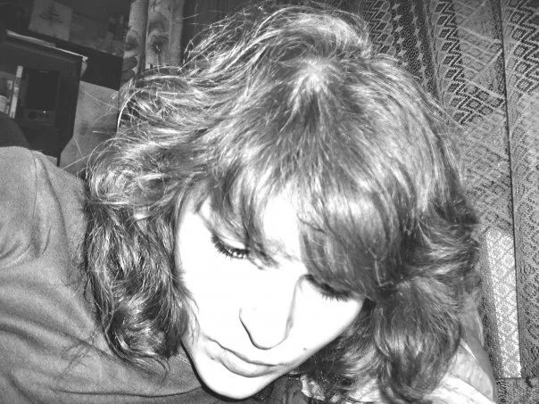 Black and white close-up portrait in dramatic lighting.