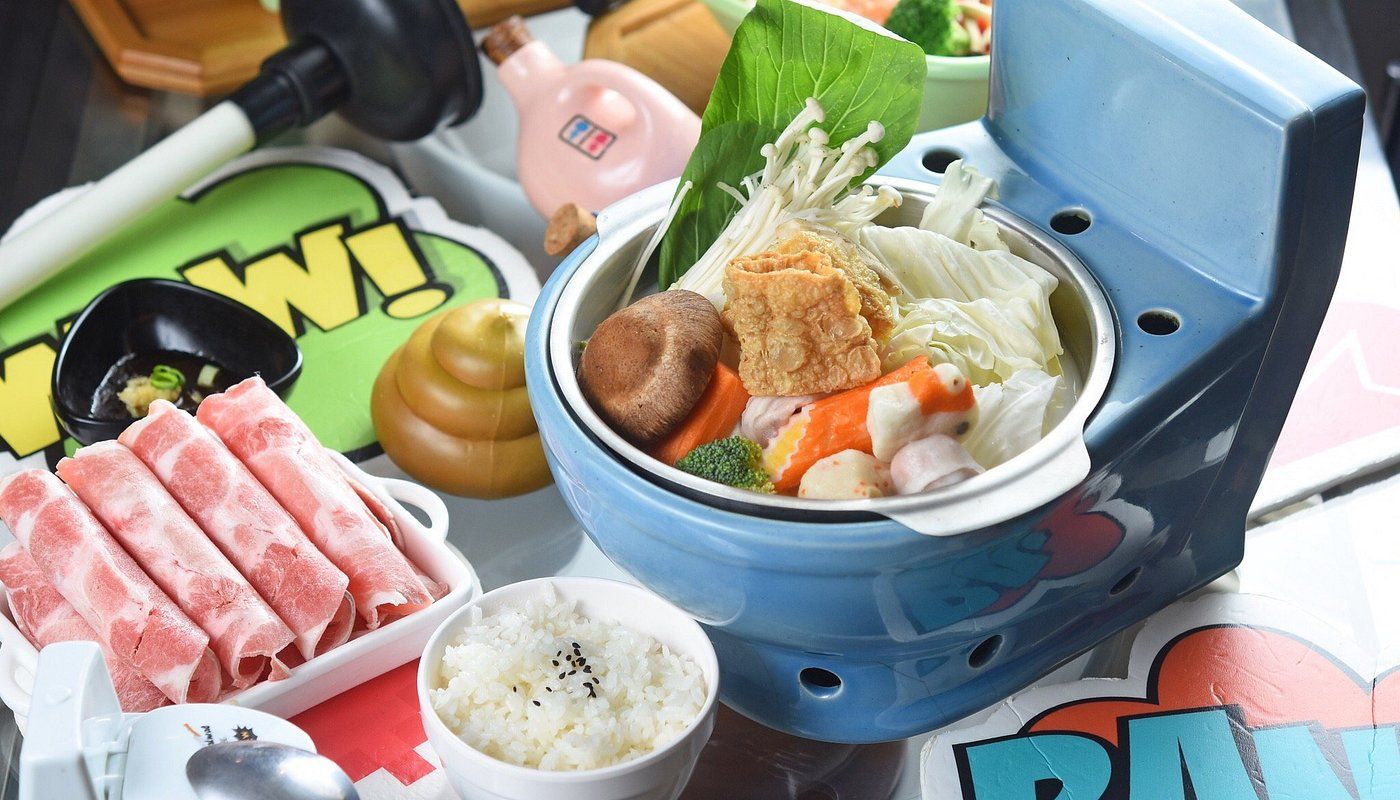 Various hot pot ingredients and dishes arranged on a blue dining table.