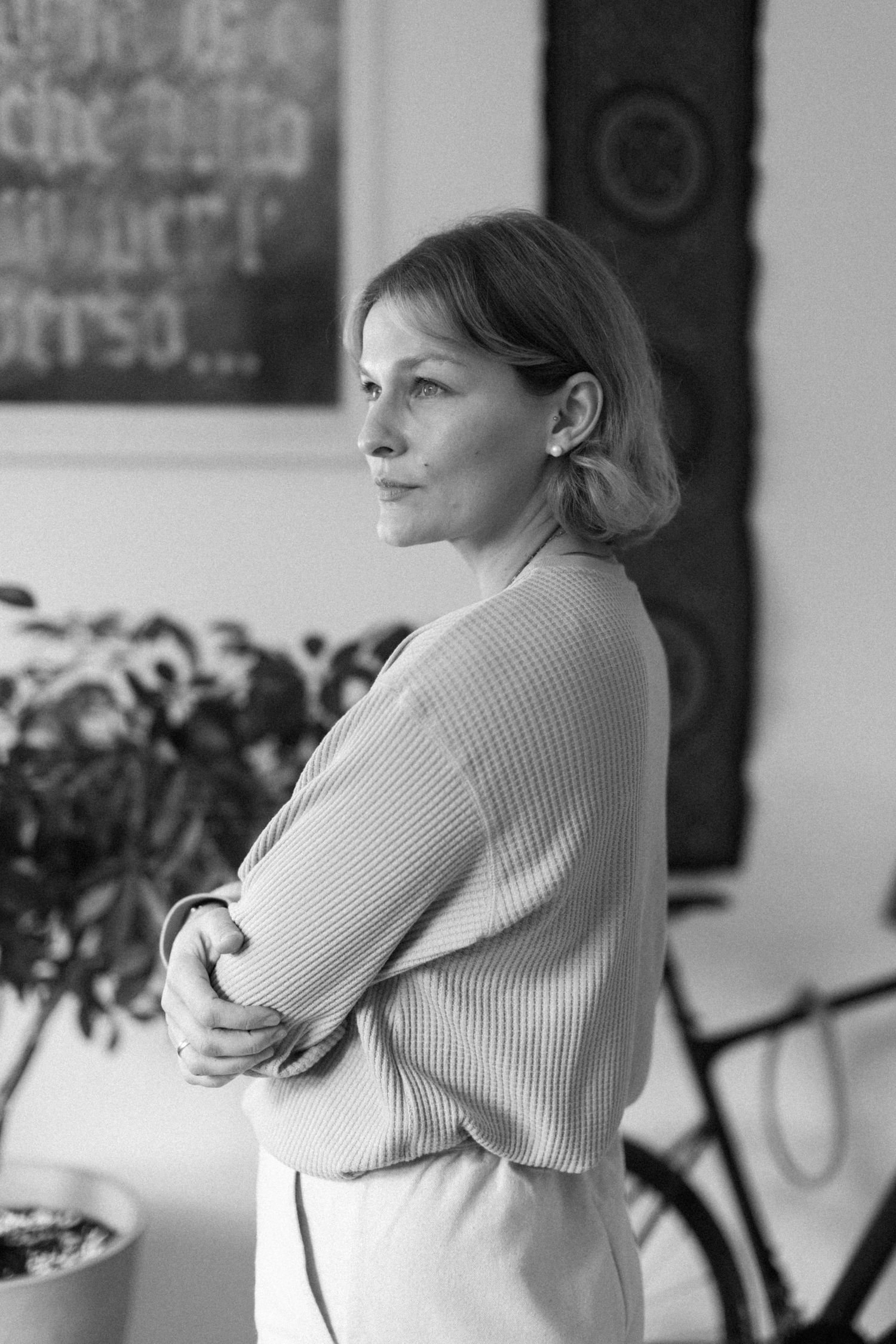 Black and white photo series showing someone in a ribbed sweater hugging themselves.