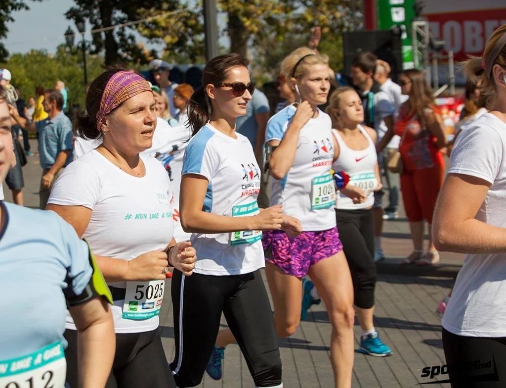Large group of runners participating in an outdoor race event on a sunny day.