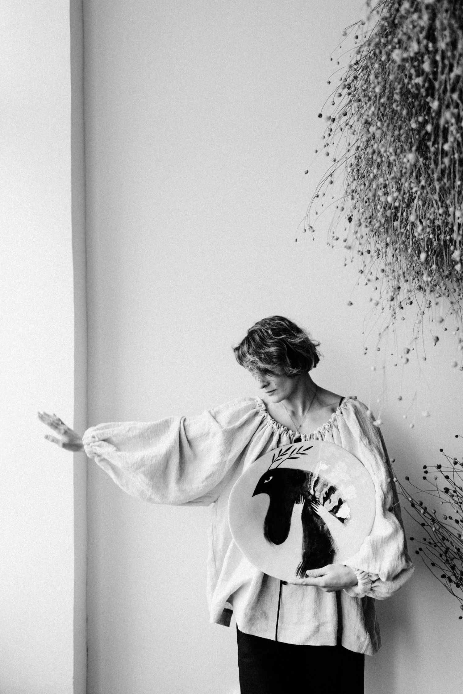 Black and white sequence showing expressive dance movements against a wall with dark splatters.