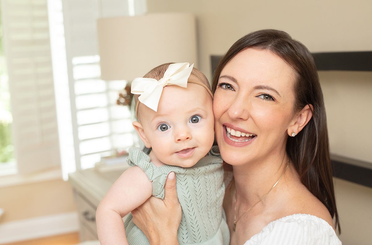 Douglasville family photographer capturing a mom and daughter moment in a cozy bedroom