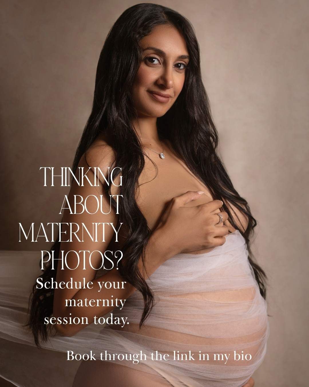 Pregnant woman in sheer white fabric poses for maternity photography session advertisement.