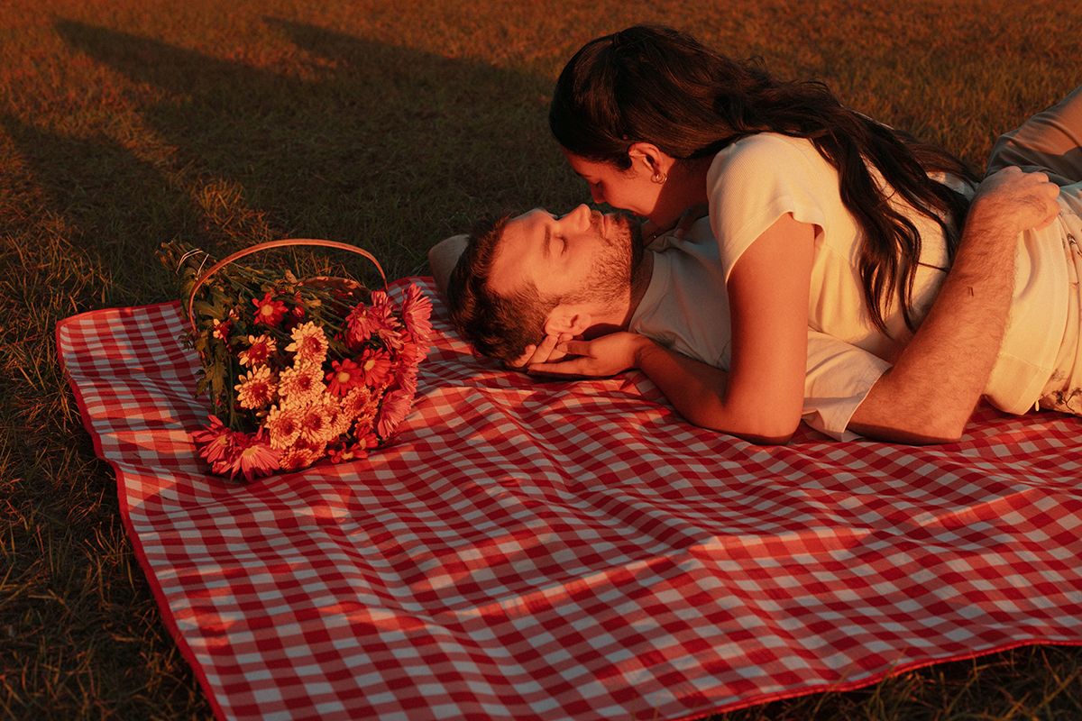 Romantic lakeside couples photoshoot at sunset with warm golden light and natural connection near Atlanta, Georgia.