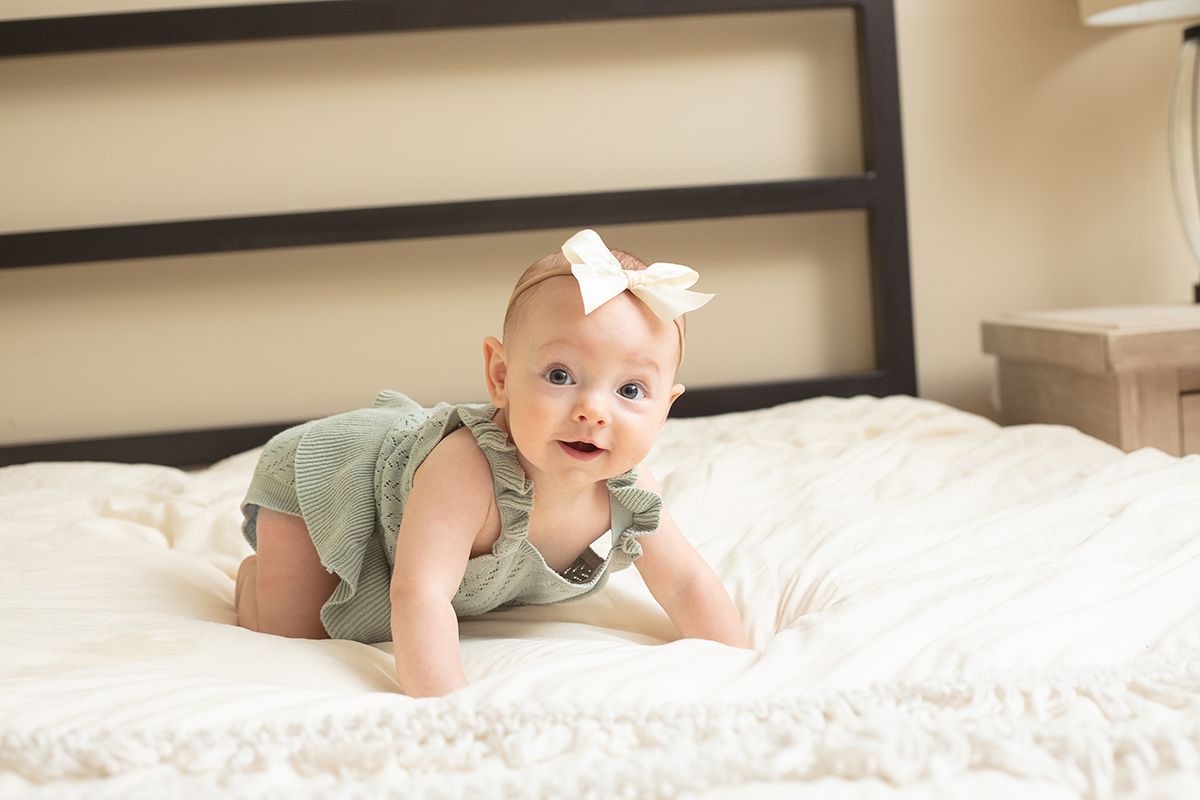 Douglasville family photographer capturing baby in a cozy bedroom