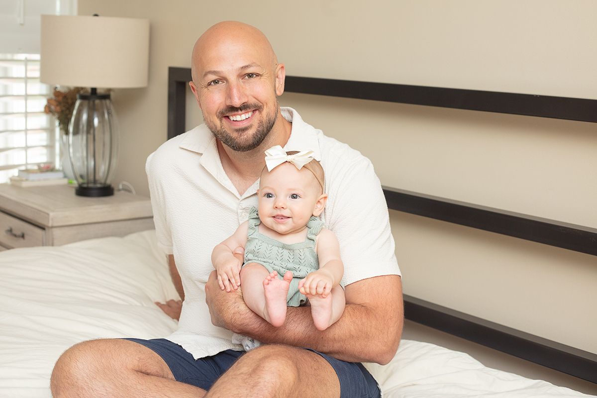 Atlanta family photographer capturing a dad and daughter moment in a cozy bedroom