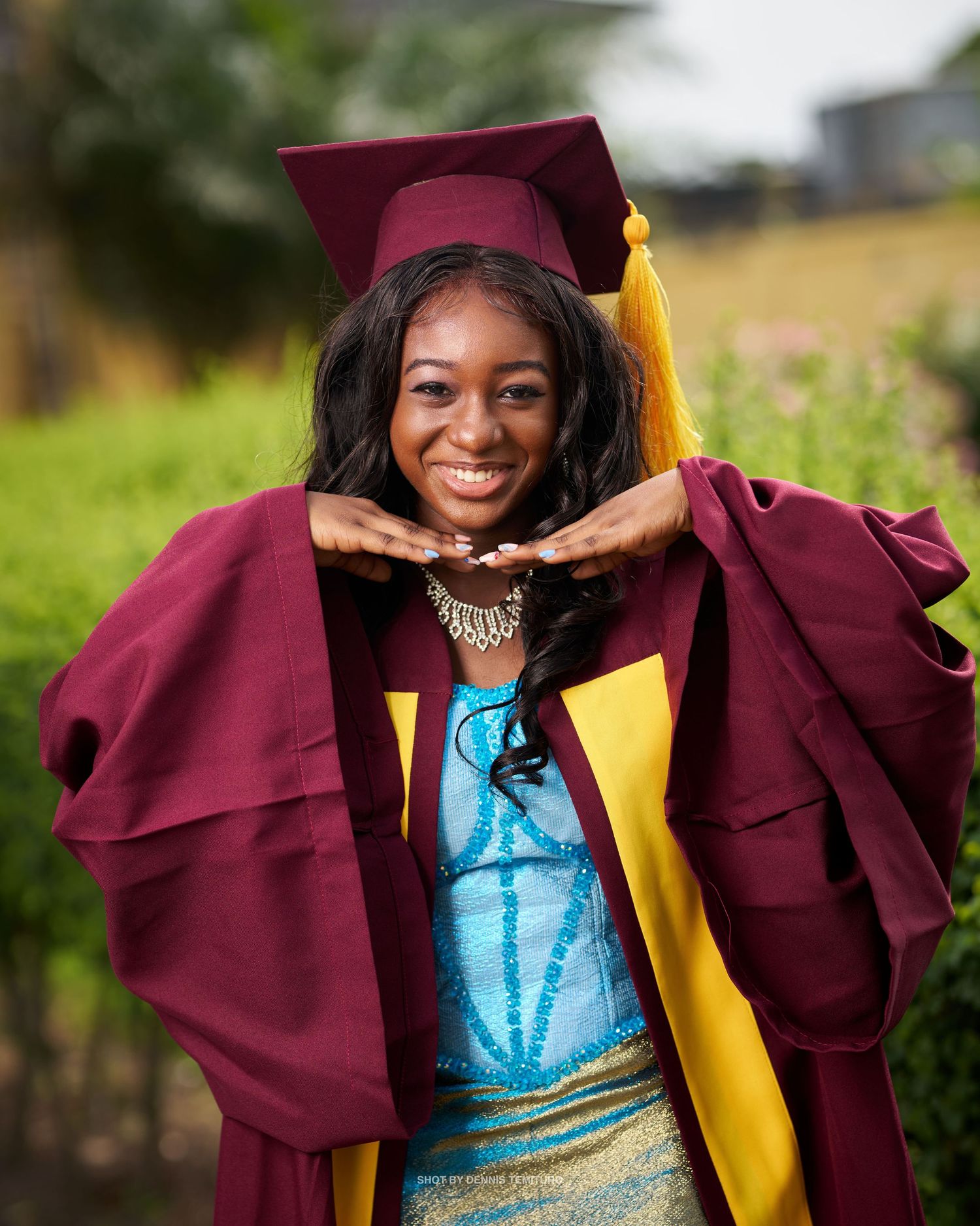 Celebratory graduation photos in maroon cap and gown with turquoise dress.