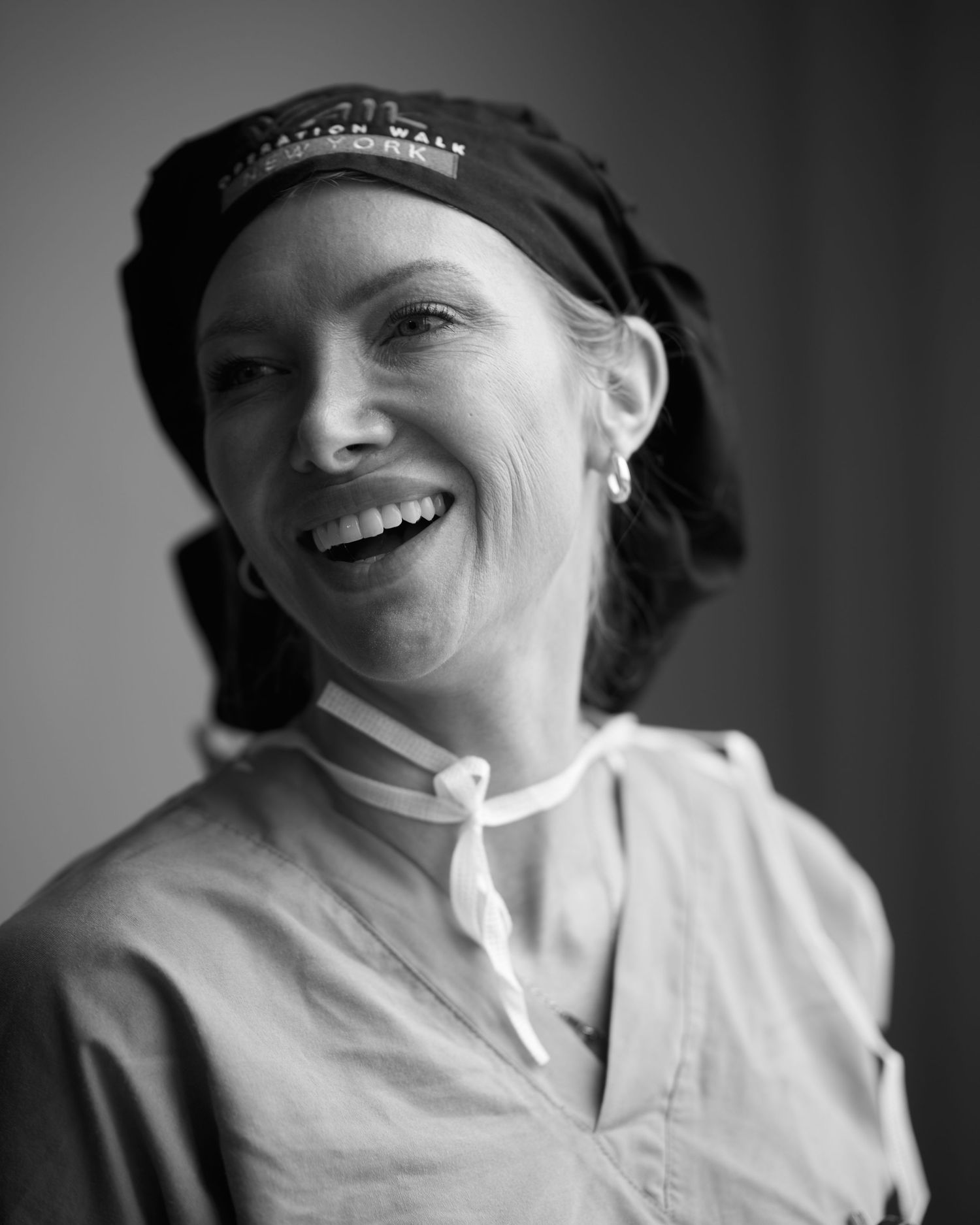 Black and white series showing medical professional in scrubs and cap.