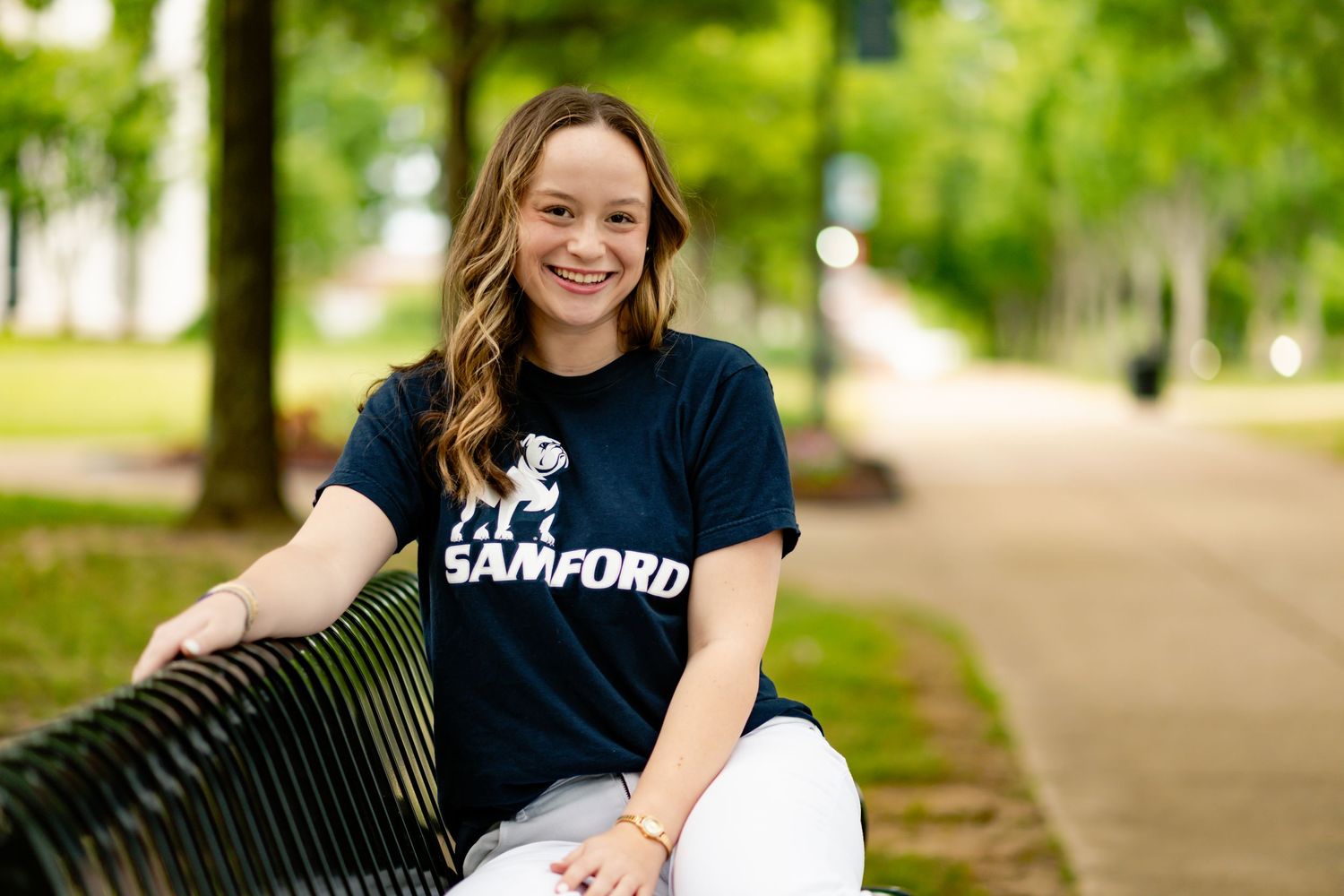 Casual campus photos wearing a navy Samford University t-shirt outdoors.