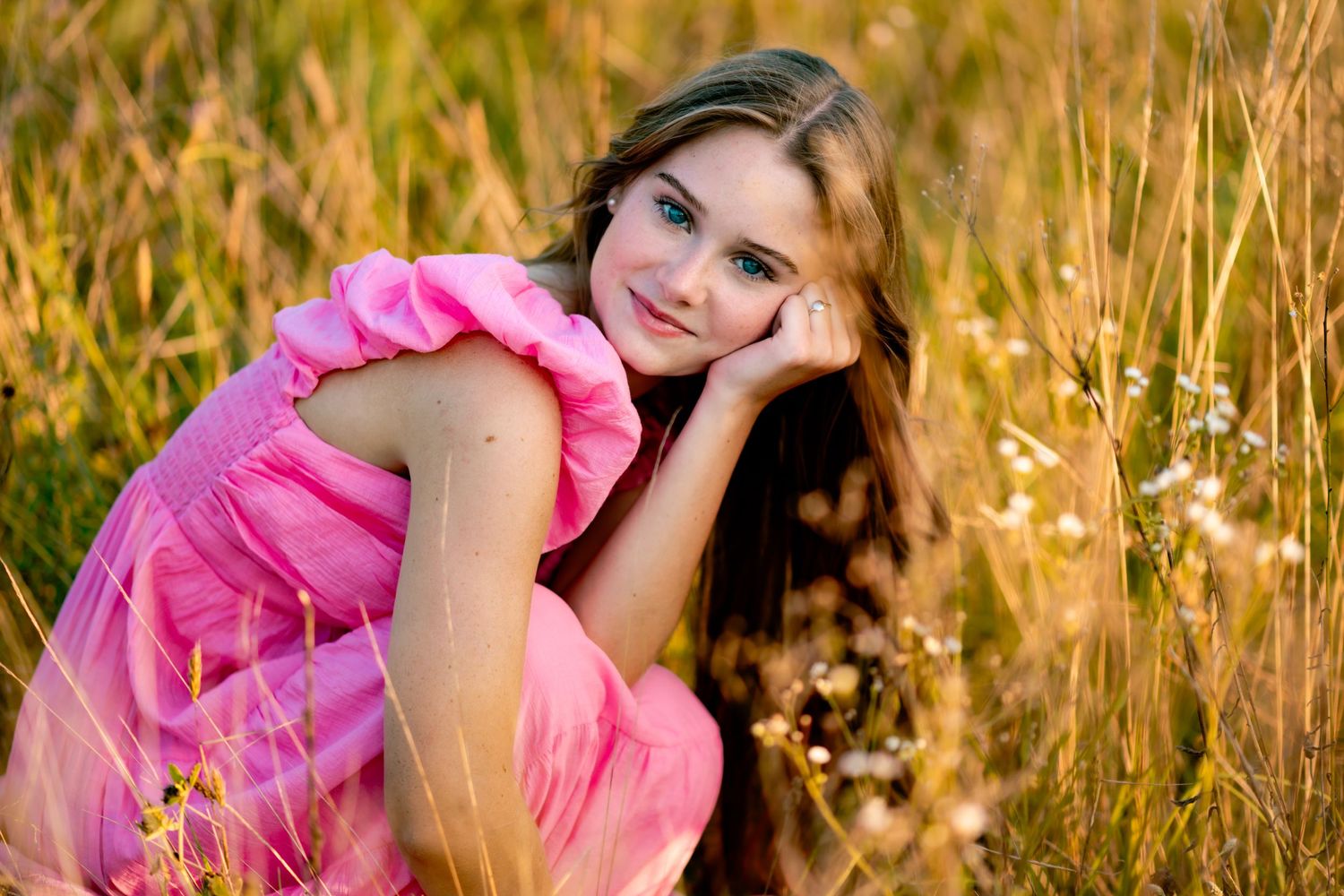 Dreamy outdoor photo series with a pink dress amid golden wheat fields at sunset.