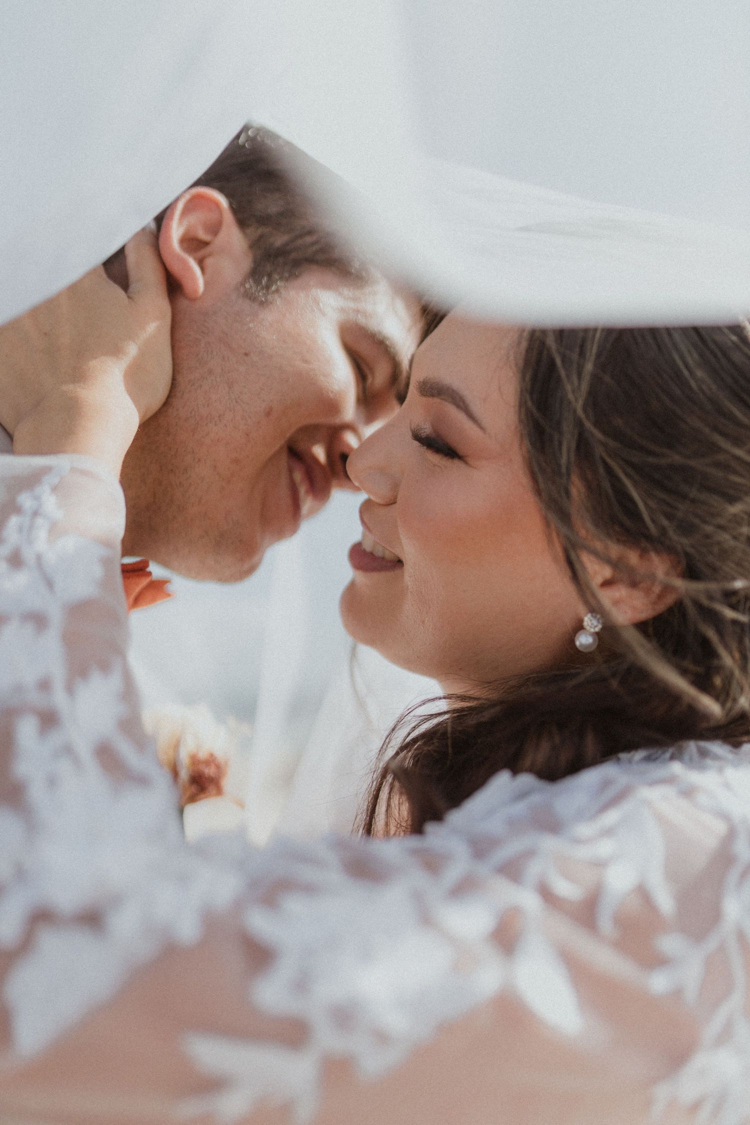 Romantic closeup of newlyweds sharing a tender moment.