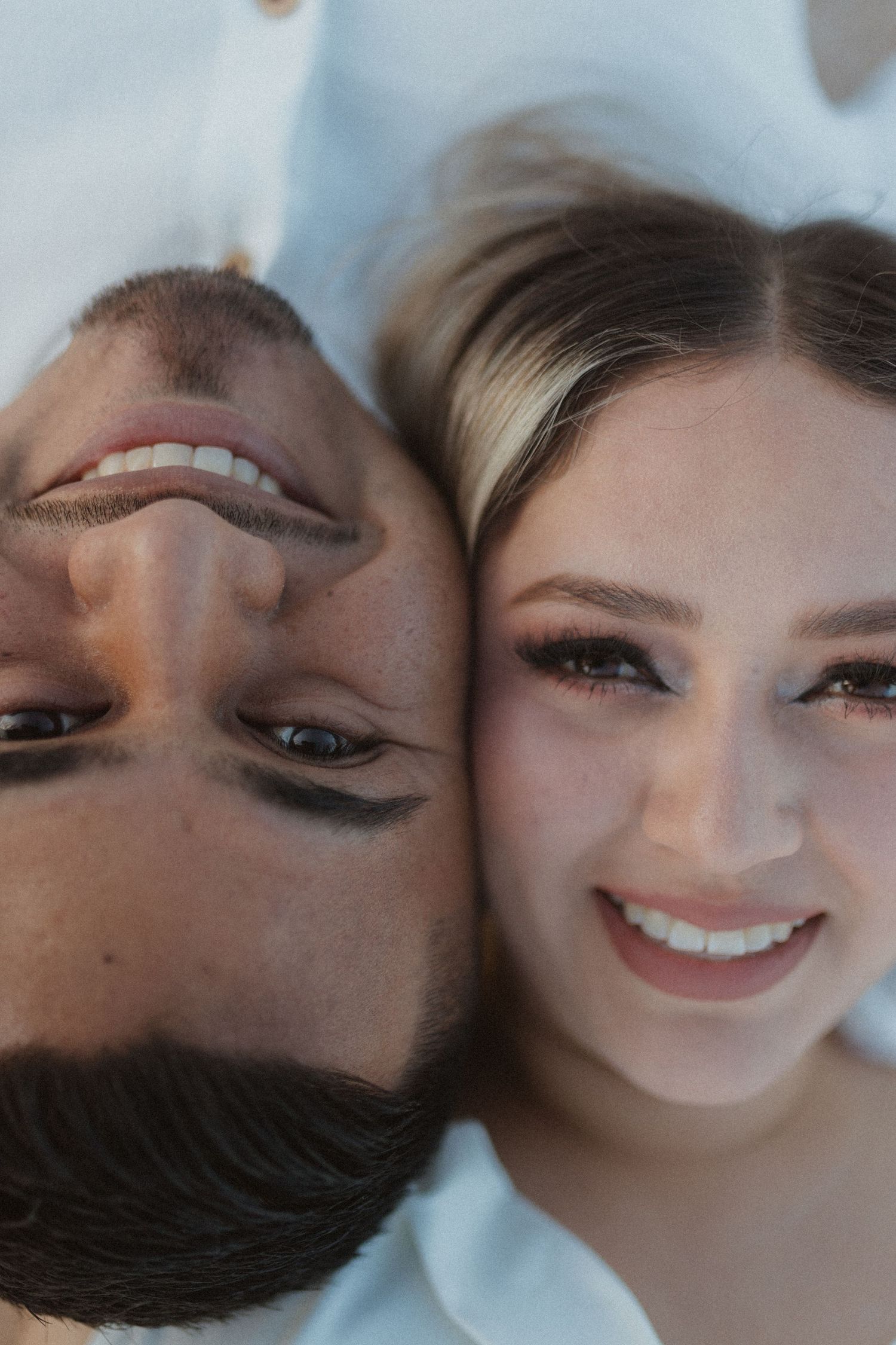Close-up romantic portrait showing joyful smiles and loving expressions.