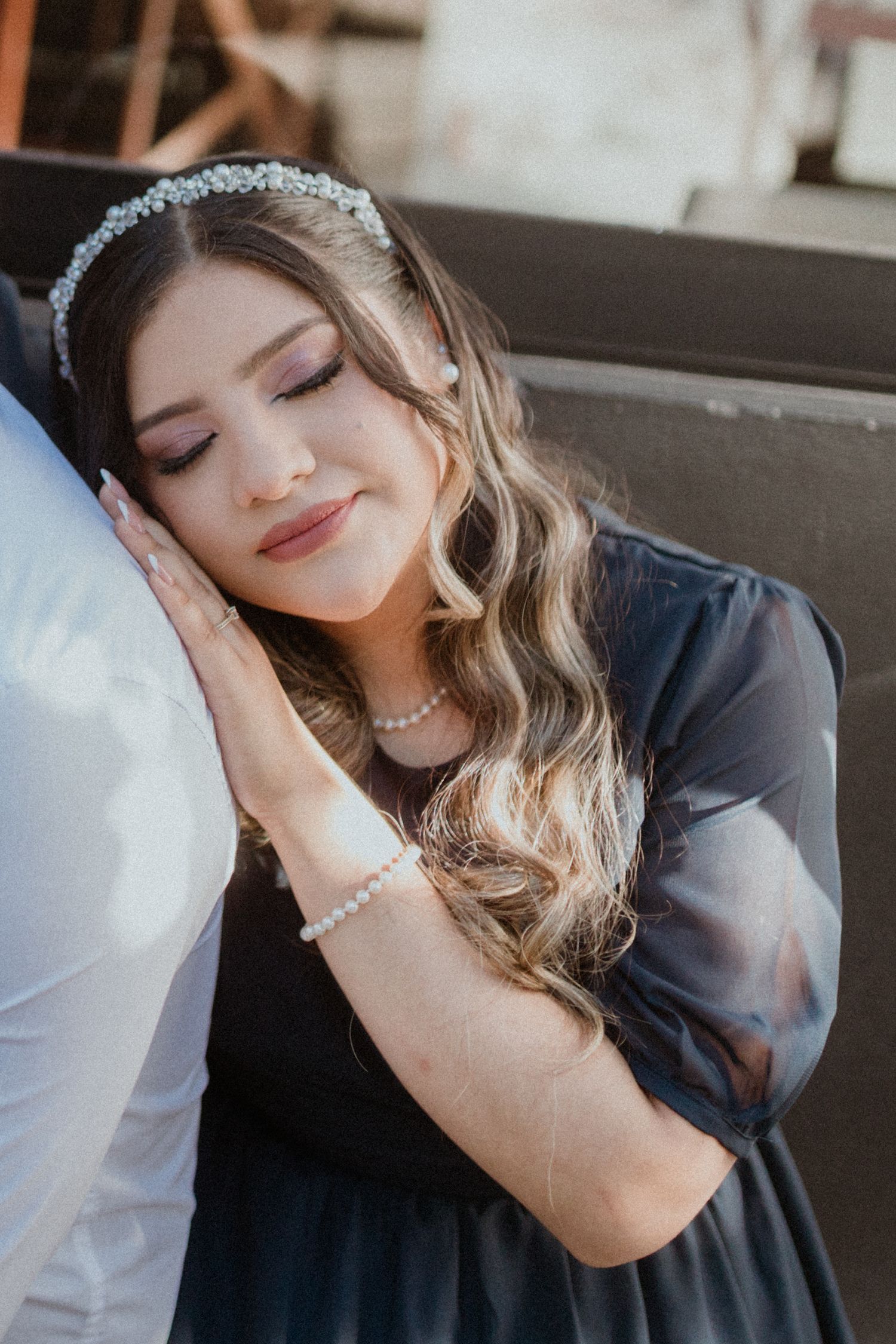 Intimate moment captured with soft lighting and elegant bridal accessories.
