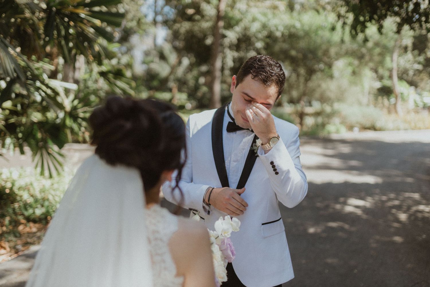 Emotional wedding moments captured in natural outdoor setting.