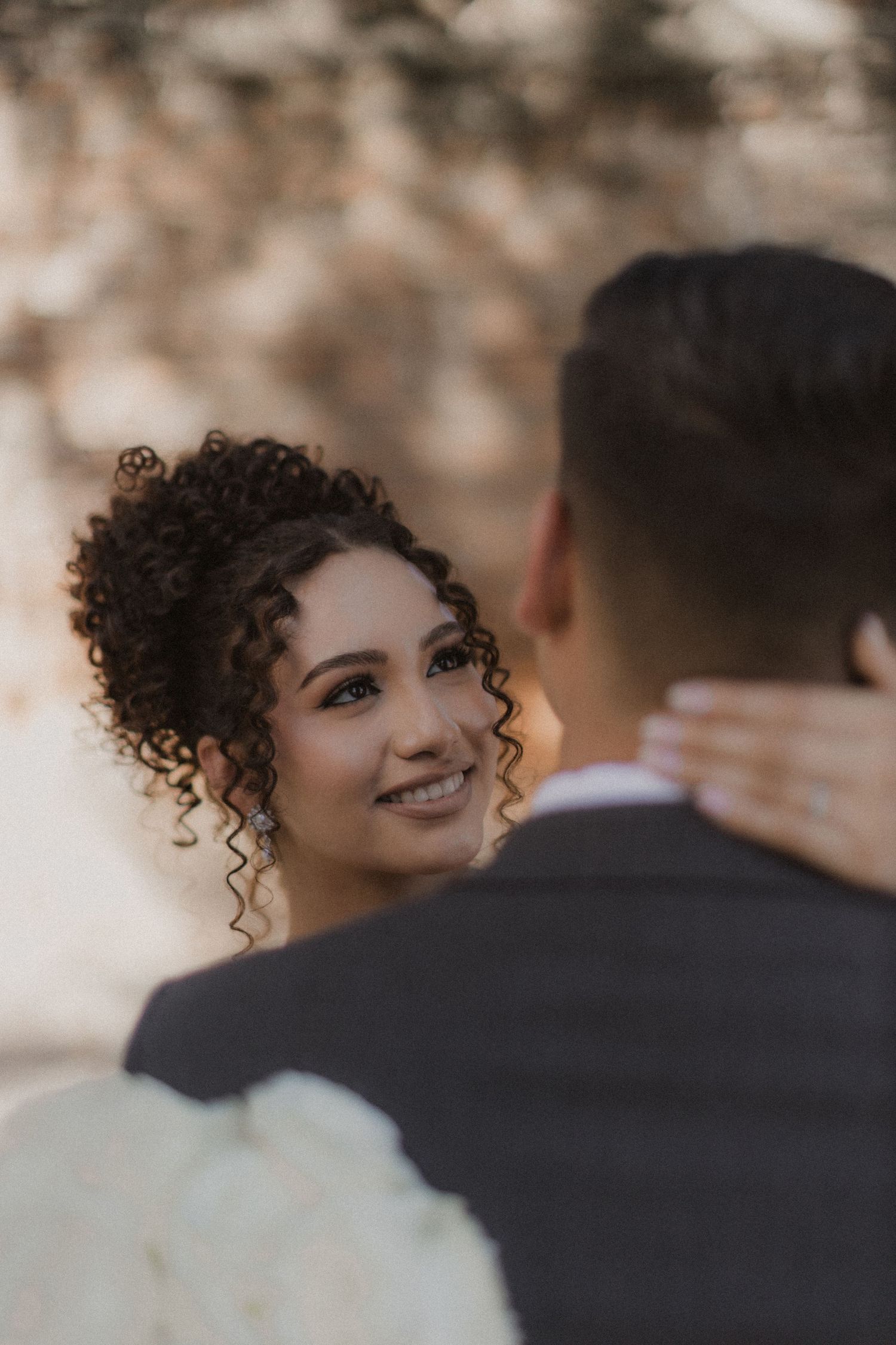 A romantic wedding moment captured with soft natural lighting and bokeh effects.