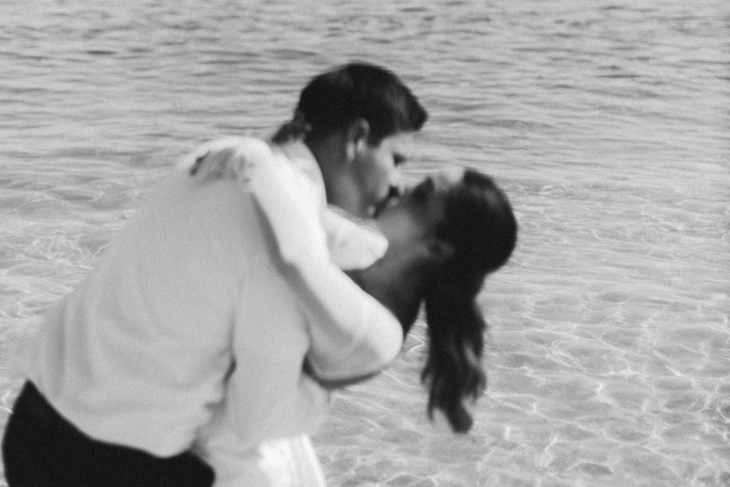 A romantic black and white dance photo near the water.