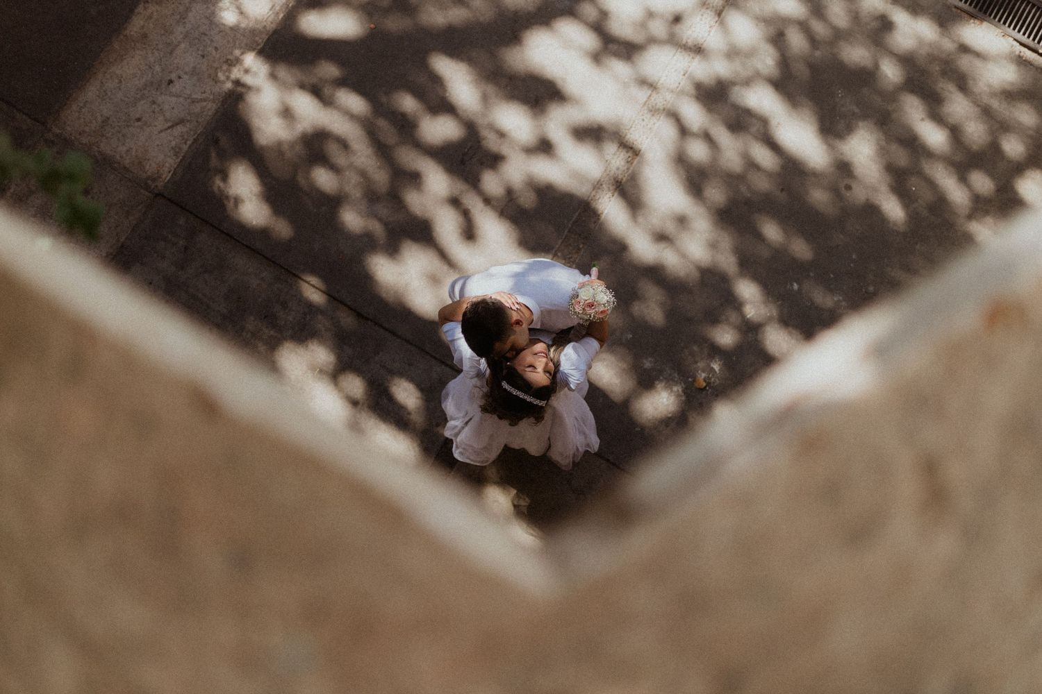 Looking down at ground level showing scattered shadows and textures.