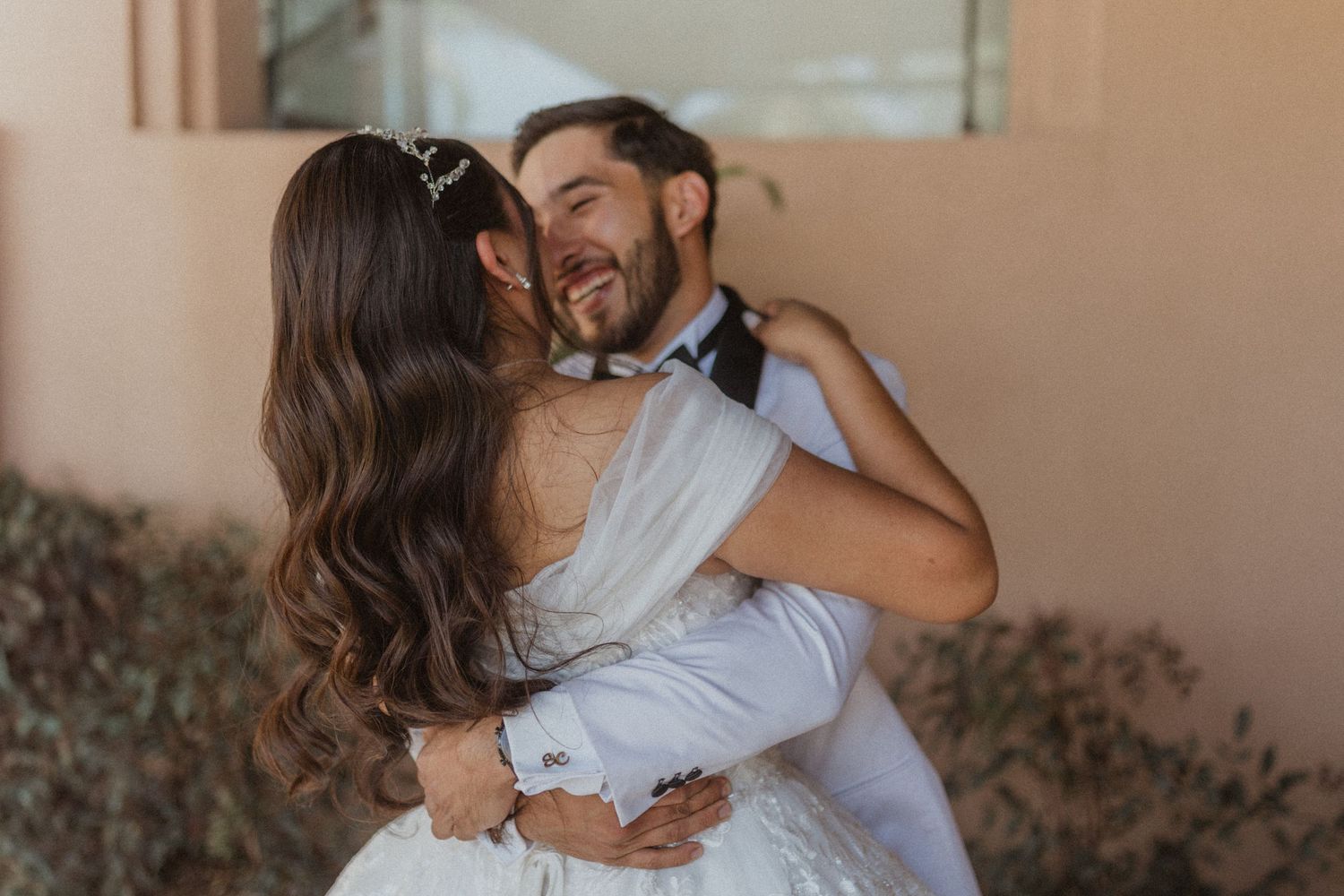 A romantic embrace between newlyweds during their wedding photoshoot.