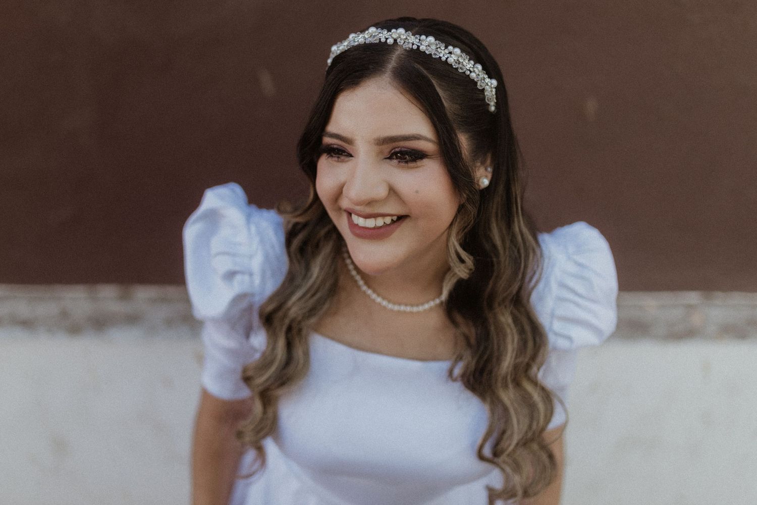 Close-up showing white dress details and elegant bridal accessories.