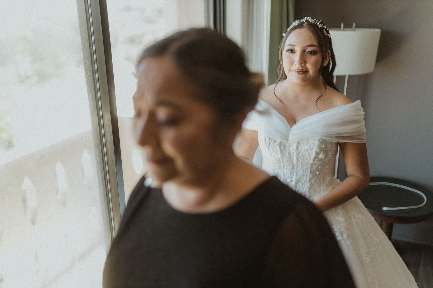 Multiple frames capture tender moments of wedding day preparation by a window.