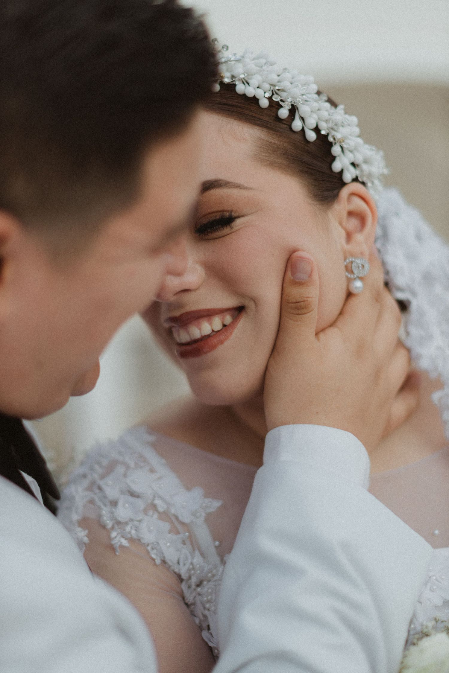 Tender moment between newlyweds showing genuine laughter and emotional connection.