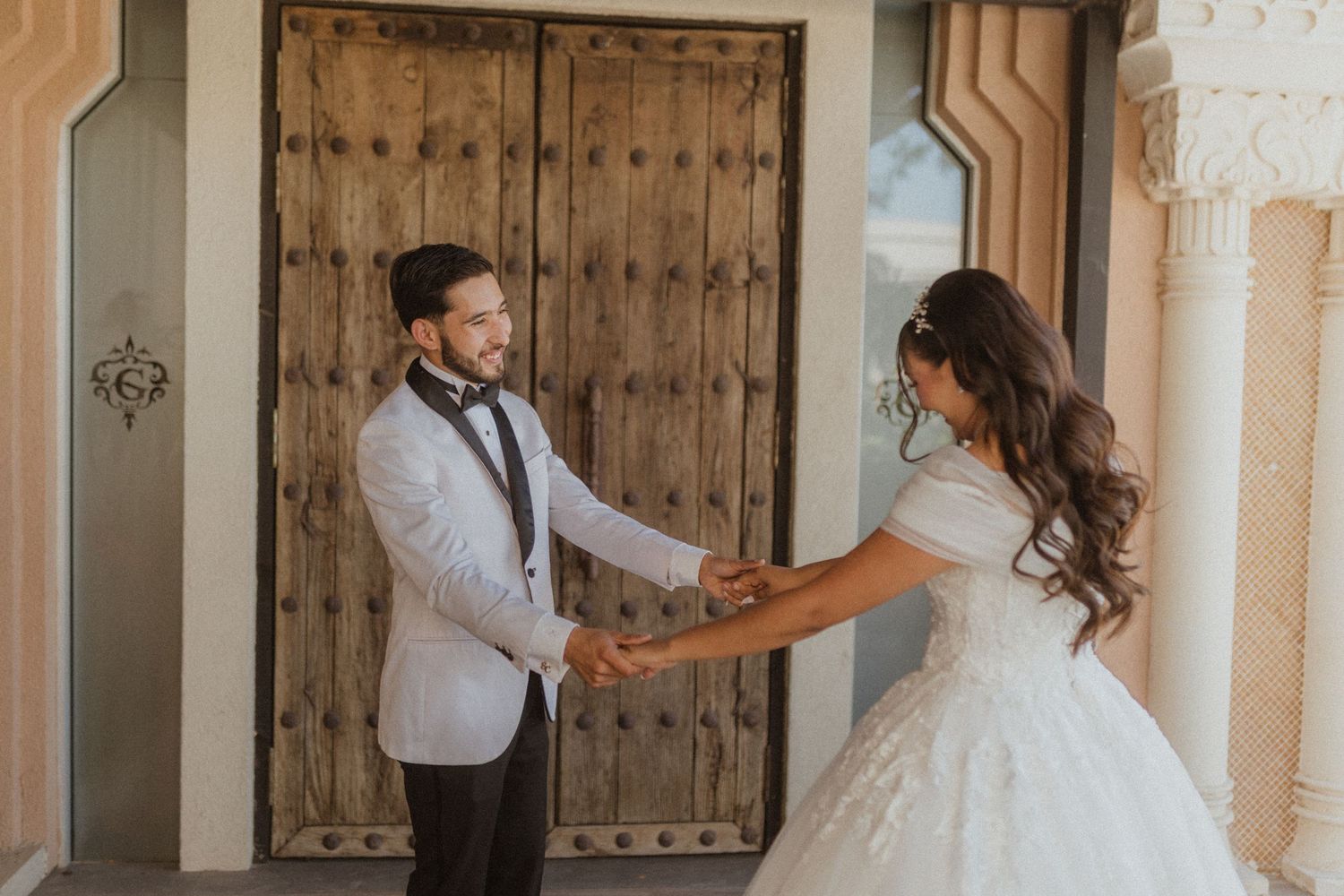A couple dances and holds hands during their wedding celebration.