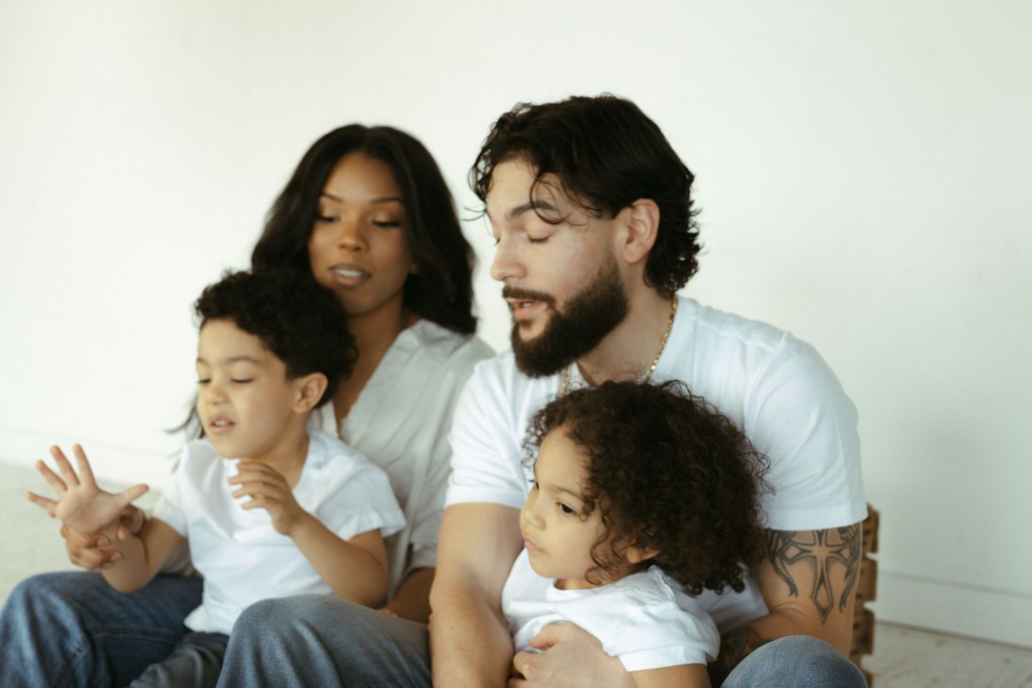 Happy family in white shirts sharing a playful moment together.