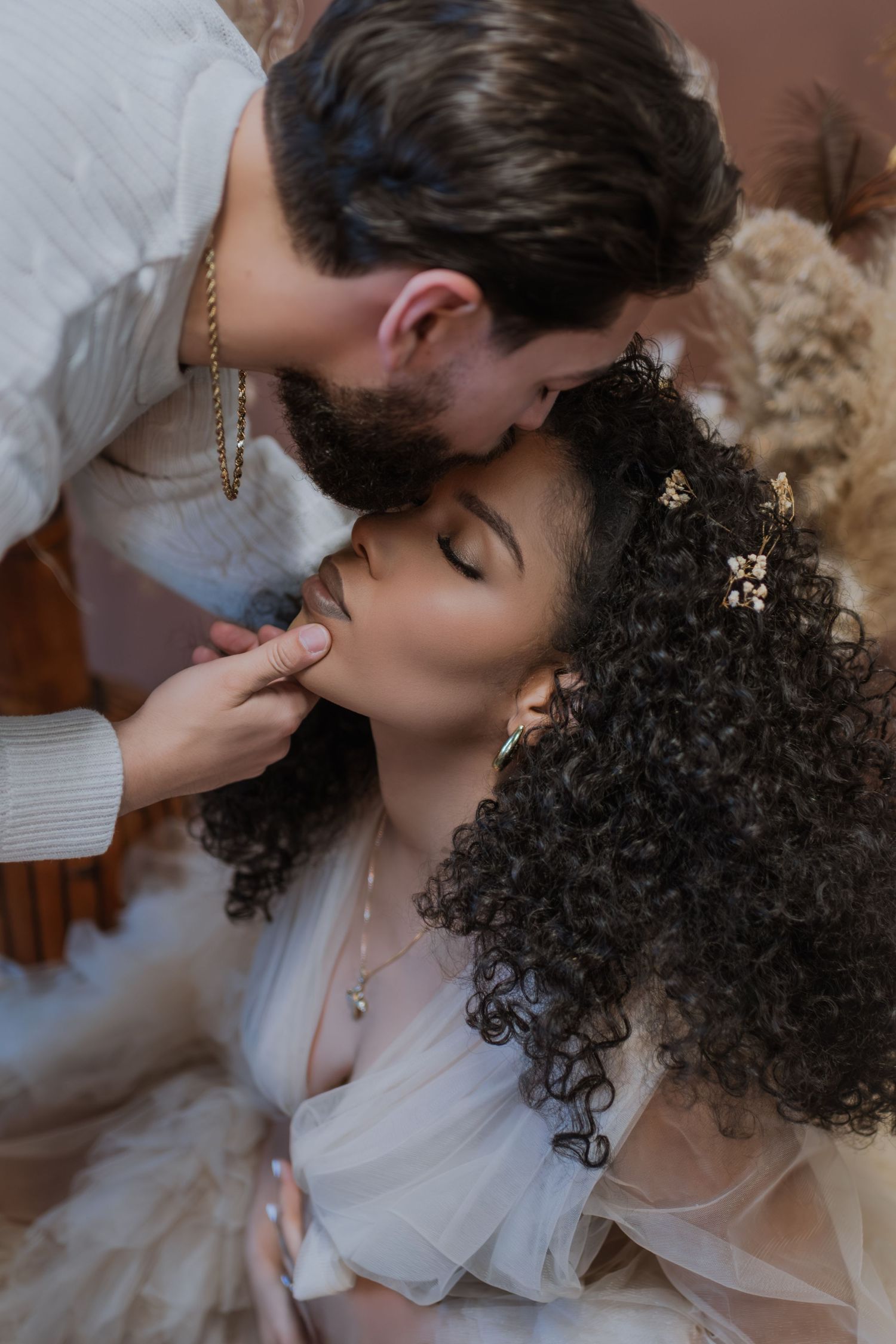 A romantic sequence of wedding photos showing a couple sharing an intimate kiss in soft lighting.
