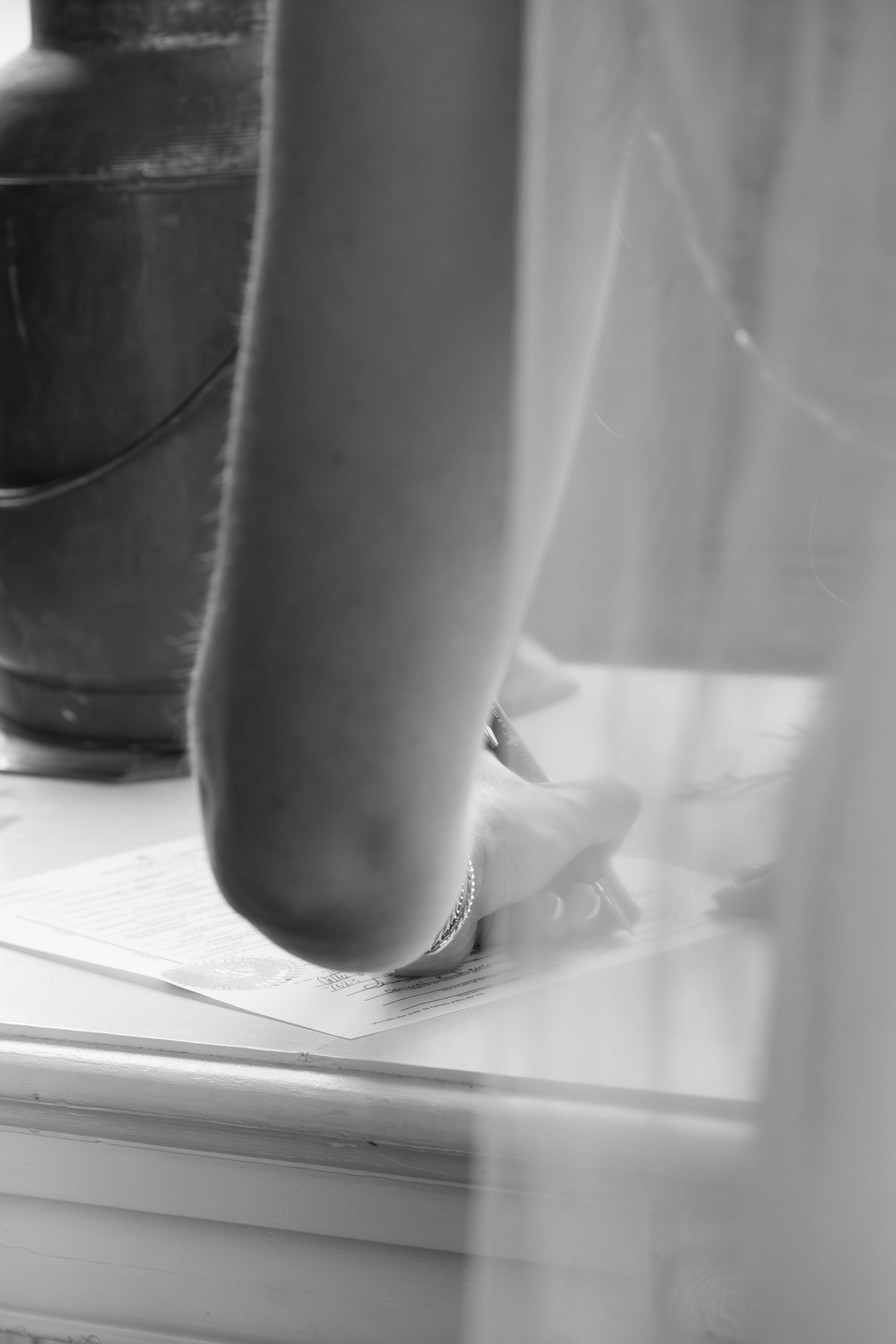Artistic black and white close-up of an object's edge against soft fabric.