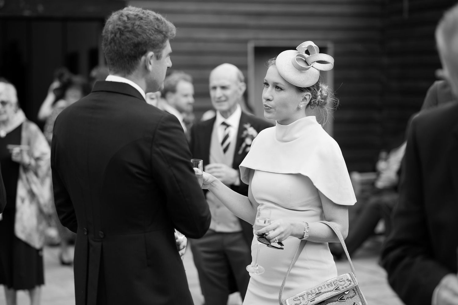Black and white wedding reception photos show guests dancing and celebrating on the dance floor.