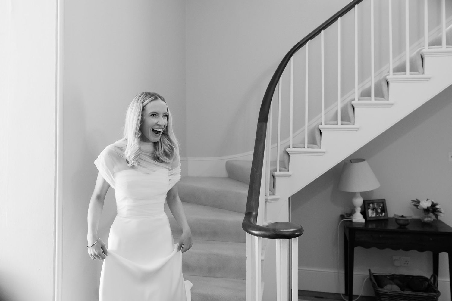 Wedding gown detail shot on a curved staircase with natural light.