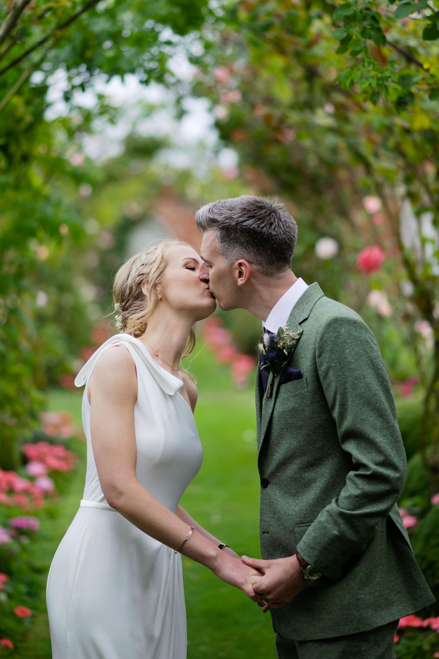 Romantic moment captured in a blooming garden with roses and greenery.