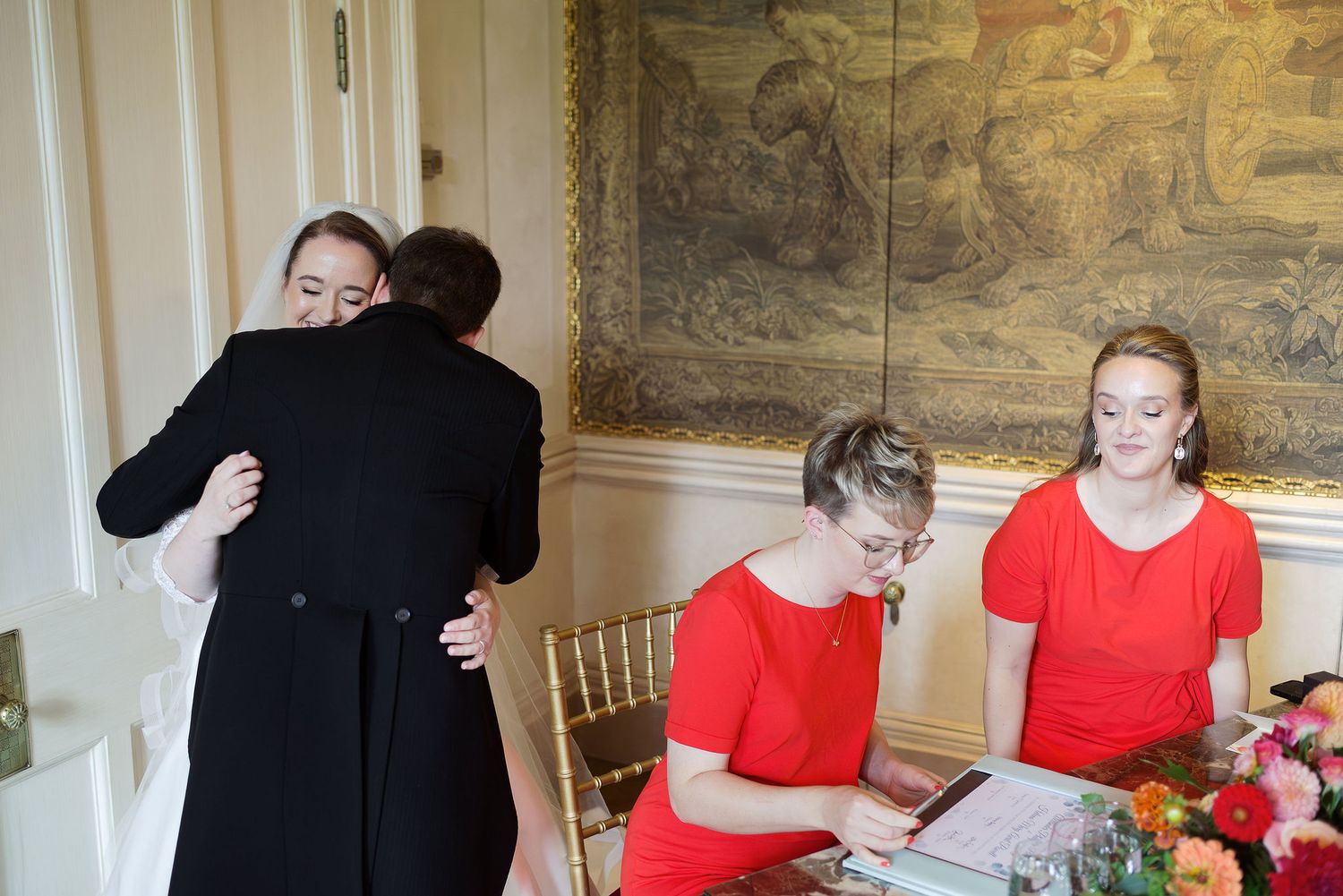 A series of photos showing people in formal attire at a special event with red and black color coordination.