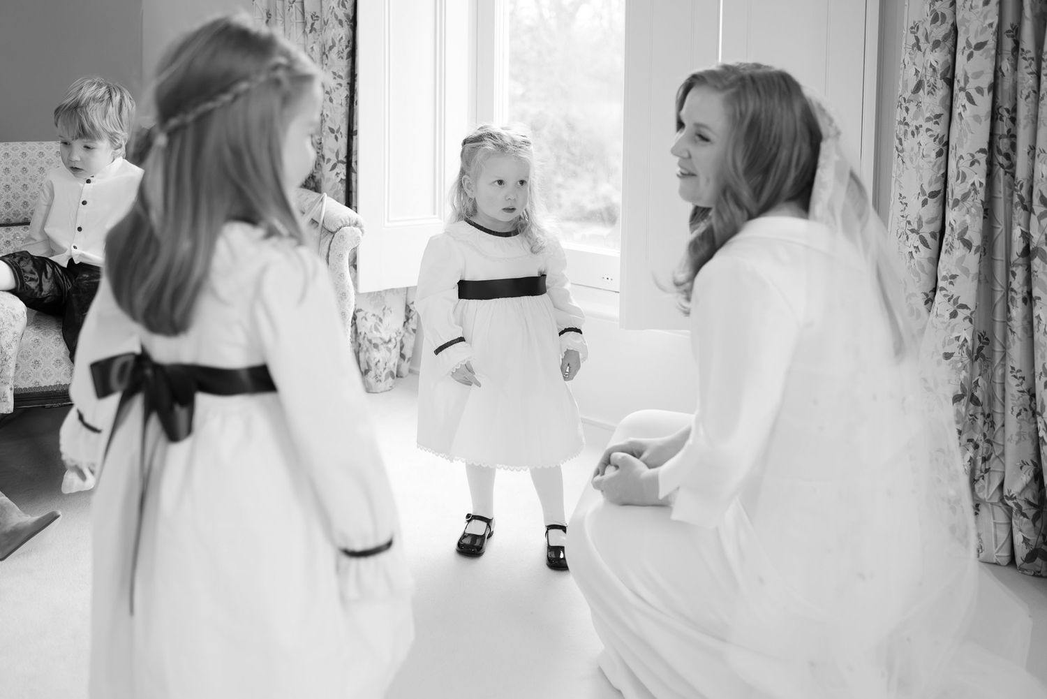 A series of black and white photos showing a bride and groom getting ready and celebrating their wedding day.