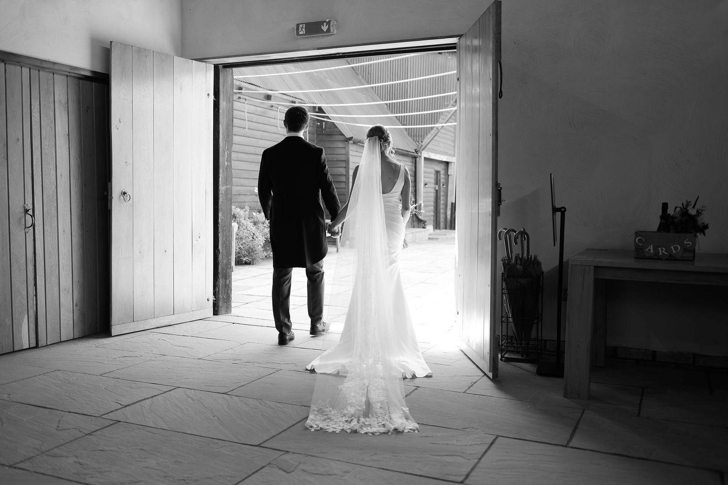 Black and white photo series showing silhouettes in a bright doorway during a wedding.