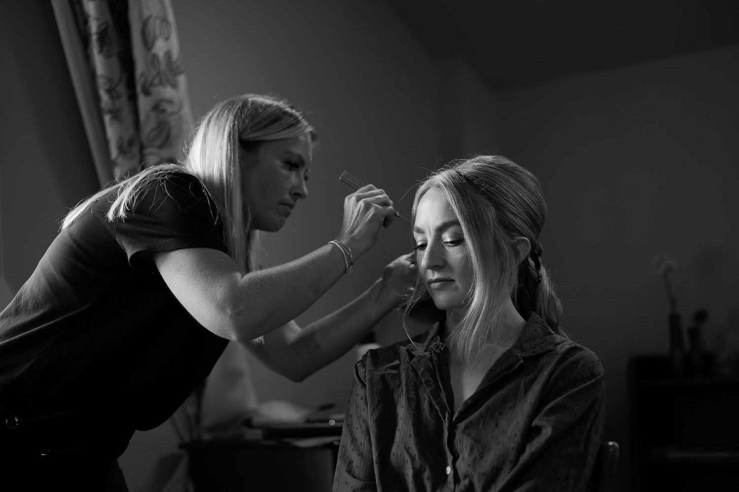 Intimate black and white photography of wedding day preparations.